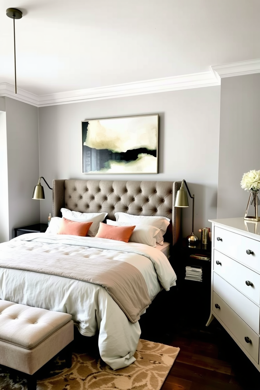 A cozy bedroom featuring a plush king-sized bed with a tufted headboard dressed in soft neutral linens. Statement lighting fixtures include a pair of modern pendant lights hanging above the bedside tables, casting a warm glow in the space. The walls are painted in a soft gray tone, complemented by a large abstract artwork above the bed. A stylish area rug anchors the room, while a sleek dresser with a minimalist design sits opposite the bed, enhancing the overall aesthetic.