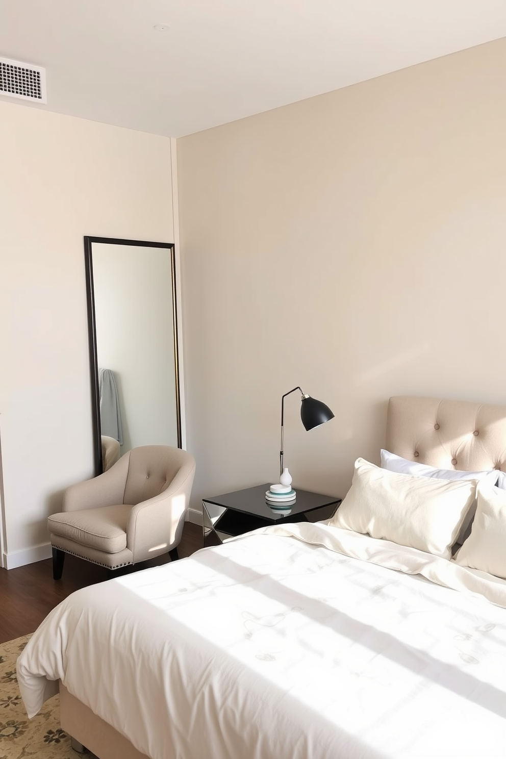 A cozy bedroom in a modern apartment featuring a large wall-mounted mirror that reflects natural light. The bed is dressed in soft linens with a plush headboard, and a stylish bedside table holds a contemporary lamp. The walls are painted in a soft beige, creating a warm atmosphere. A small seating area with a comfortable chair and a decorative rug adds a touch of elegance to the space.