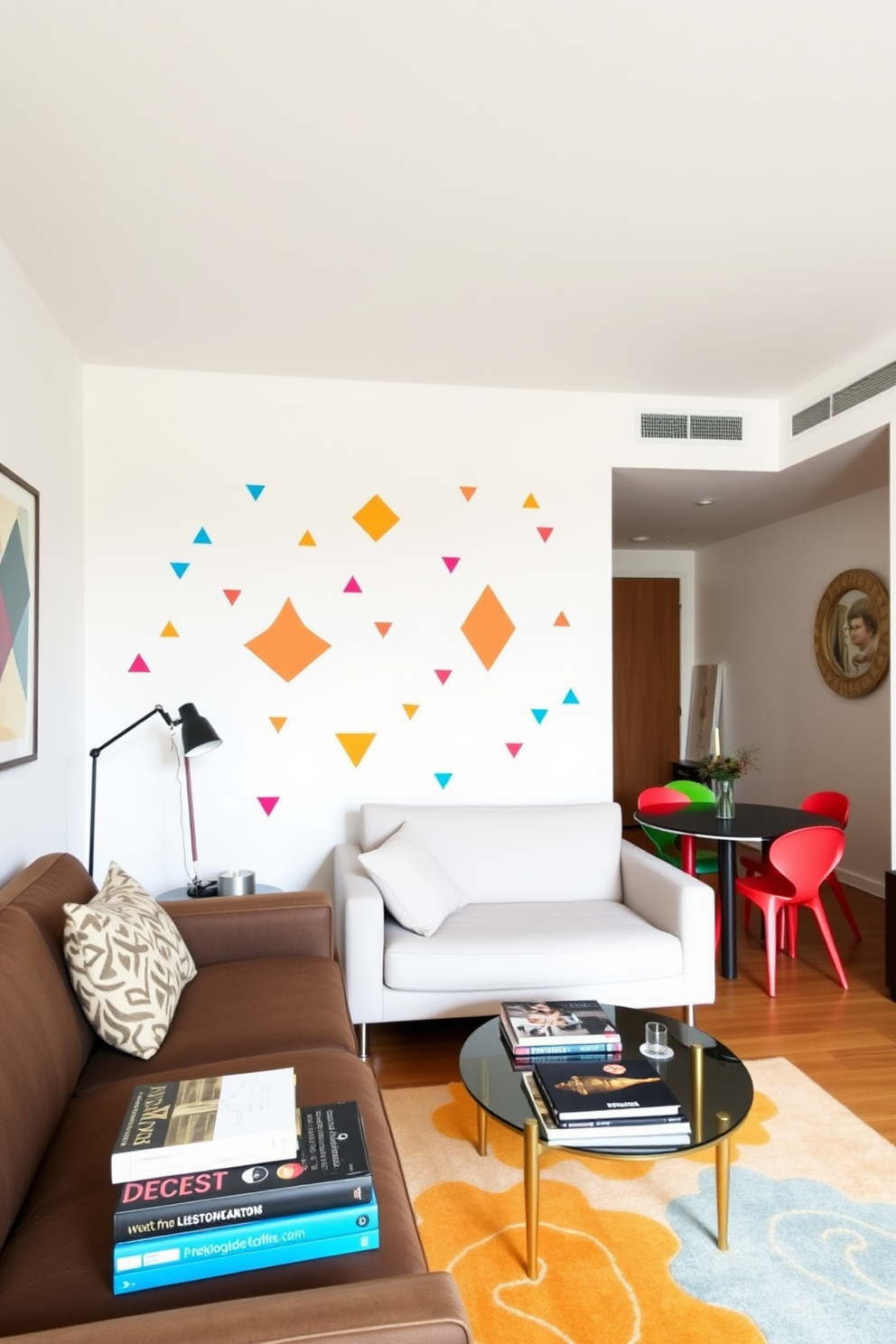 A modern apartment featuring wall decals that add a playful touch to the living space. The decals are in vibrant colors and geometric shapes, creating an energetic atmosphere throughout the 500 sqft layout. The open-plan design includes a cozy seating area with a stylish sofa and a coffee table adorned with decorative books. A small dining nook with a round table and colorful chairs complements the overall aesthetic, making it perfect for entertaining guests.