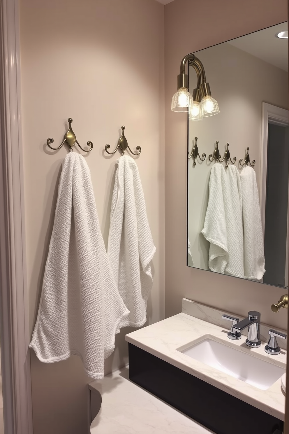 A stylish bathroom design featuring decorative hooks for towels and robes. The hooks are made of brushed nickel and are arranged in an aesthetically pleasing manner on the wall. The space includes a sleek vanity with a quartz countertop and modern fixtures. Soft ambient lighting illuminates the room, creating a warm and inviting atmosphere.