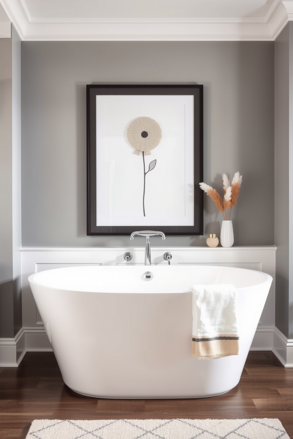 A chic bathroom featuring a striking piece of unique artwork that adds a personal touch to the decor. The artwork is framed in a sleek black frame and hangs above a modern freestanding bathtub, creating a focal point in the room. The walls are painted in a soft gray tone that complements the artwork beautifully. A stylish rug in neutral colors lies beneath the bathtub, enhancing the overall aesthetic of the space.