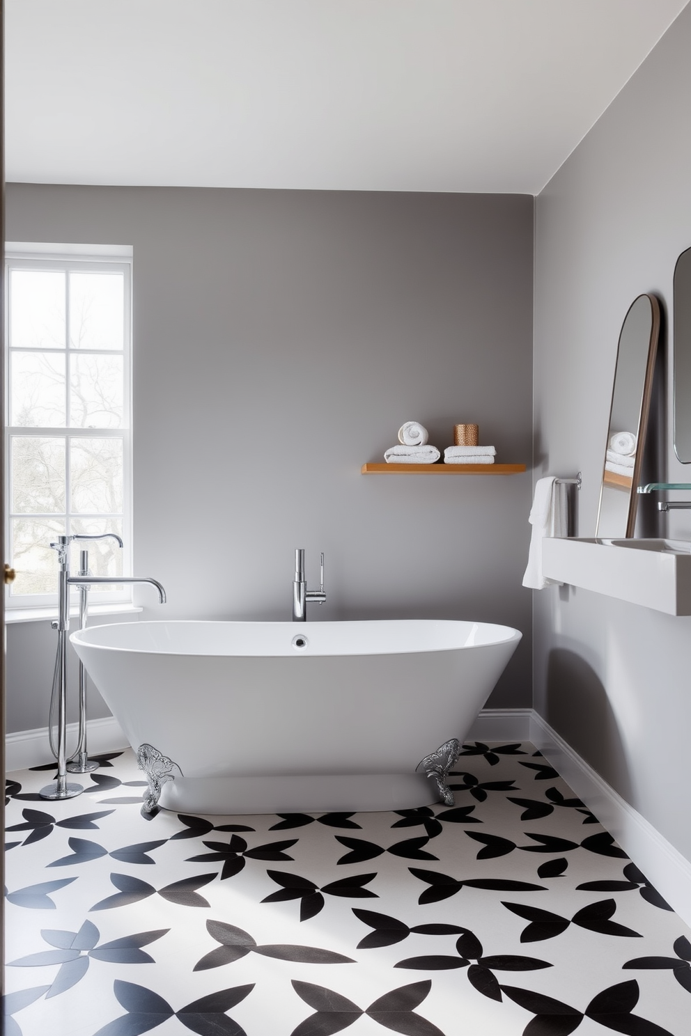 A modern bathroom featuring a floating vanity with sleek storage options and a minimalist design. The walls are adorned with large format tiles in a soft gray tone, while the floor showcases a subtle geometric pattern in white and light gray. Above the vanity, a large backlit mirror enhances the space, reflecting the natural light from a nearby window. Stylish pendant lights hang from the ceiling, providing a warm ambiance to the room.