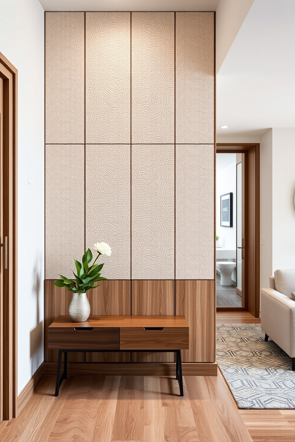 A serene apartment entryway featuring neutral tones that evoke a calming atmosphere. The space includes a sleek console table with a soft beige finish, adorned with a minimalist decorative bowl and a small potted plant. On the wall, a large round mirror reflects natural light, enhancing the sense of openness. The flooring consists of light wood planks, complemented by a textured area rug in subtle earth tones.