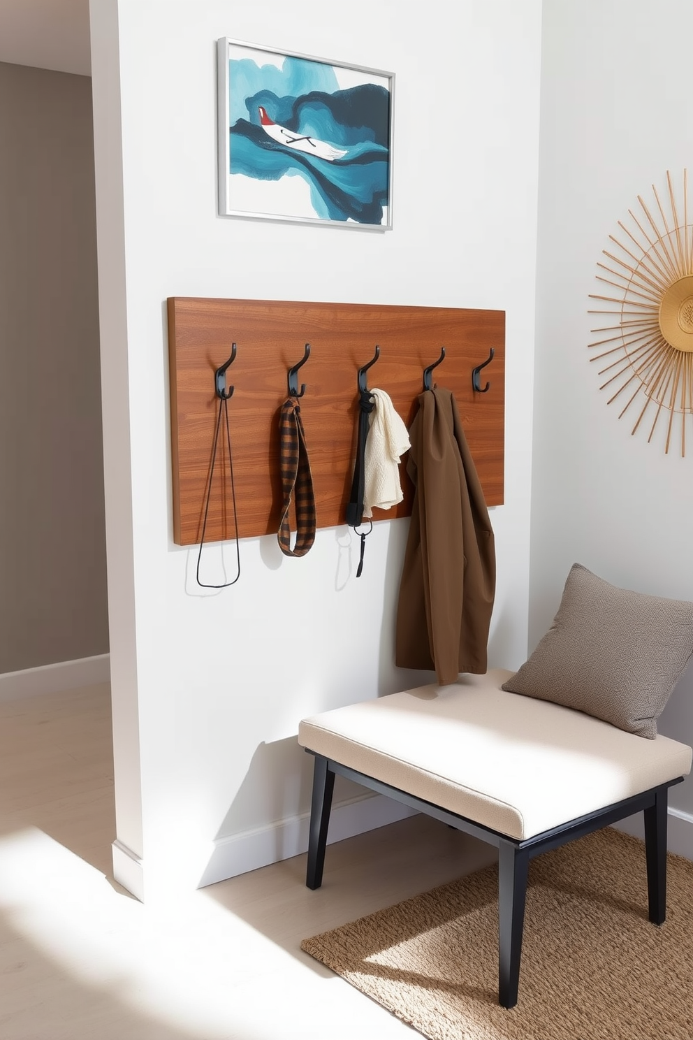 A stylish wall-mounted coat rack features a sleek wooden design with metal hooks for hanging coats and accessories. The coat rack is positioned near the entryway, complemented by a minimalist bench and decorative wall art that enhances the overall aesthetic.