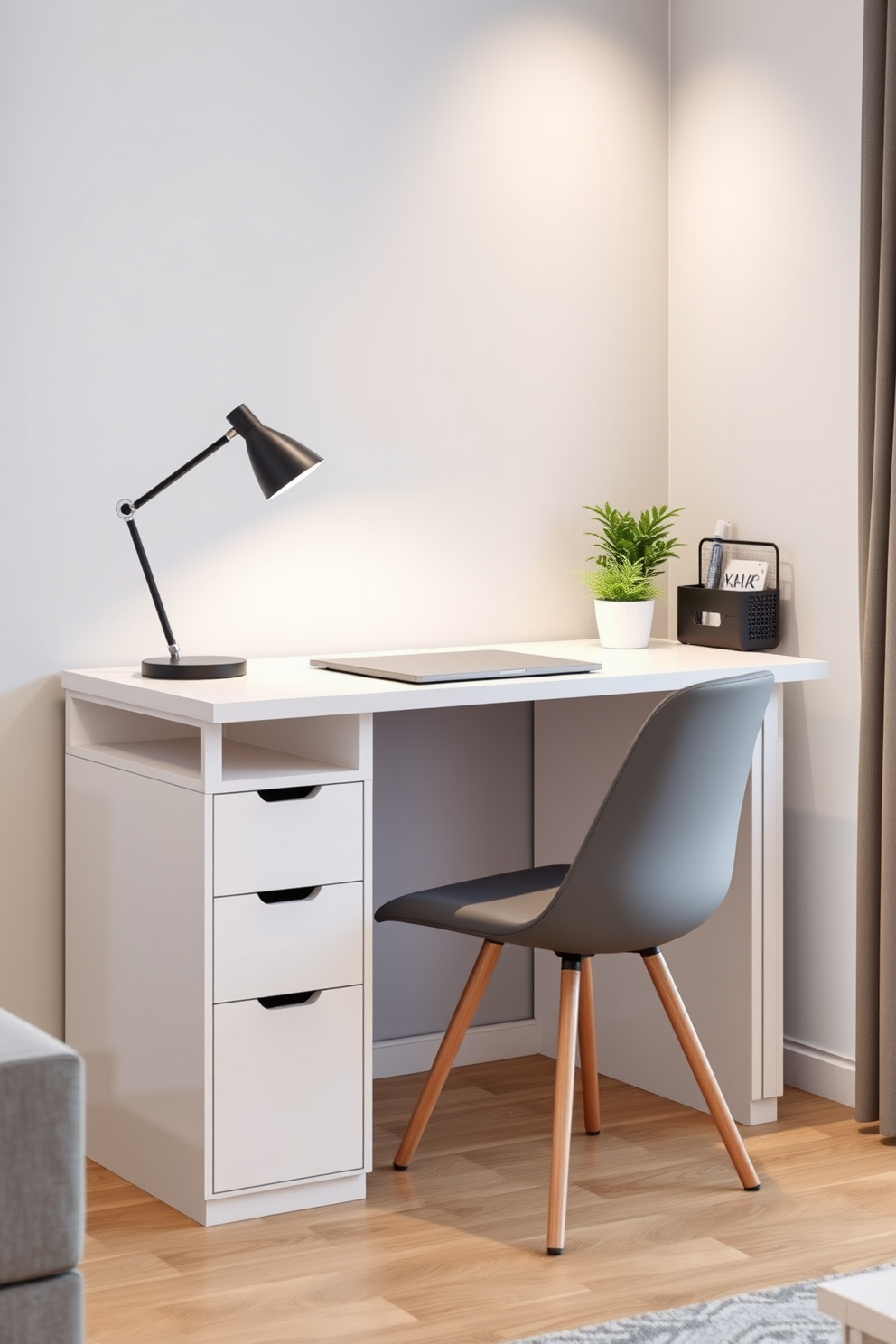 A compact desk with clean lines and a minimalist design is placed against a wall in the living area. The desk features a sleek surface with built-in storage and a comfortable chair that complements the overall color scheme of the bachelor apartment. The workspace is illuminated by a modern desk lamp that adds a touch of elegance. Surrounding the desk are decorative elements like a small potted plant and a stylish organizer, creating an inviting and functional work area.