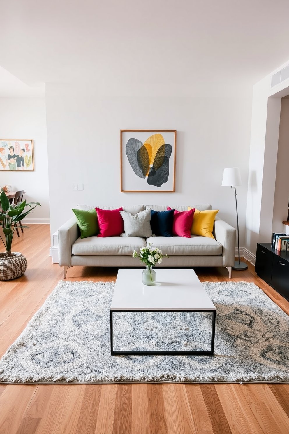 A stylish bachelor apartment featuring a neutral sofa adorned with colorful pillows that add a vibrant touch to the space. The open layout includes a sleek coffee table and a modern rug that ties the room together, creating a cozy atmosphere.