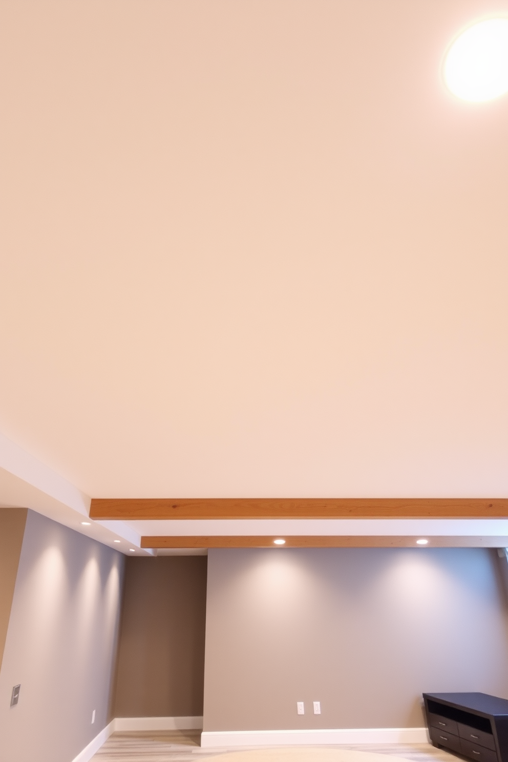 A minimalist basement ceiling design features clean lines and a sleek appearance. The ceiling is painted in a soft white color with recessed lighting that provides a warm glow, enhancing the spacious feel of the area. Exposed beams in a natural wood finish add an organic touch while maintaining a modern aesthetic. The overall design incorporates soundproofing panels in muted tones, ensuring a quiet and serene environment.