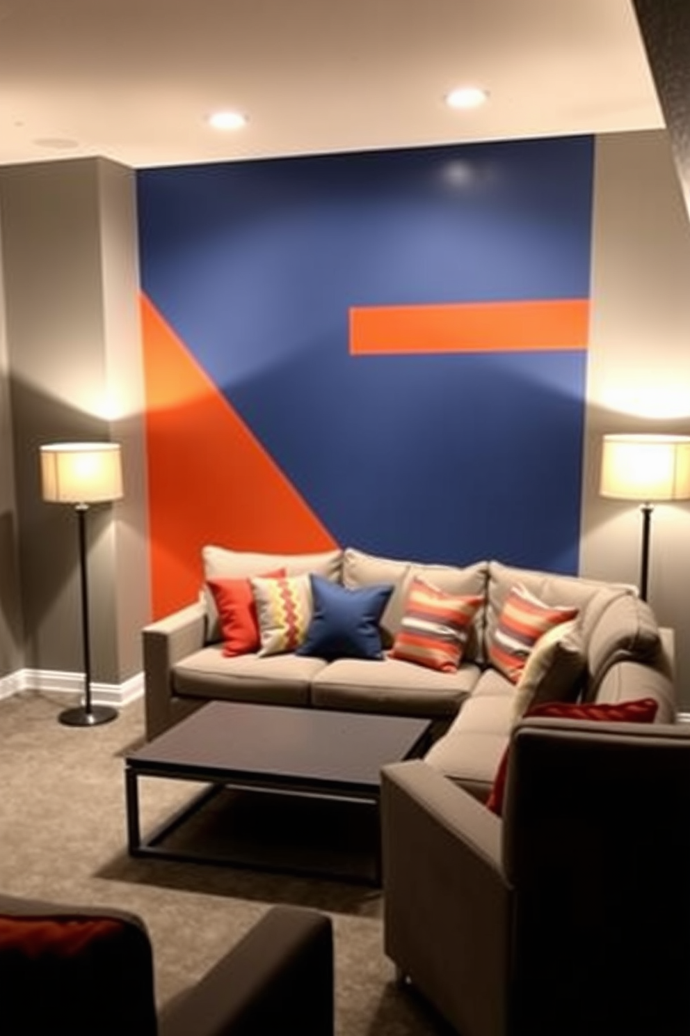 A unique accent wall features a striking combination of deep blue and vibrant orange hues that create a dynamic focal point in the basement. The surrounding walls are painted in a soft gray, enhancing the boldness of the accent wall while providing a modern and inviting atmosphere. The basement is designed with a cozy lounge area that includes a plush sectional sofa in neutral tones, accompanied by colorful throw pillows that echo the accent wall colors. A sleek coffee table sits in front of the sofa, and warm ambient lighting from stylish floor lamps creates a welcoming space for relaxation and entertainment.