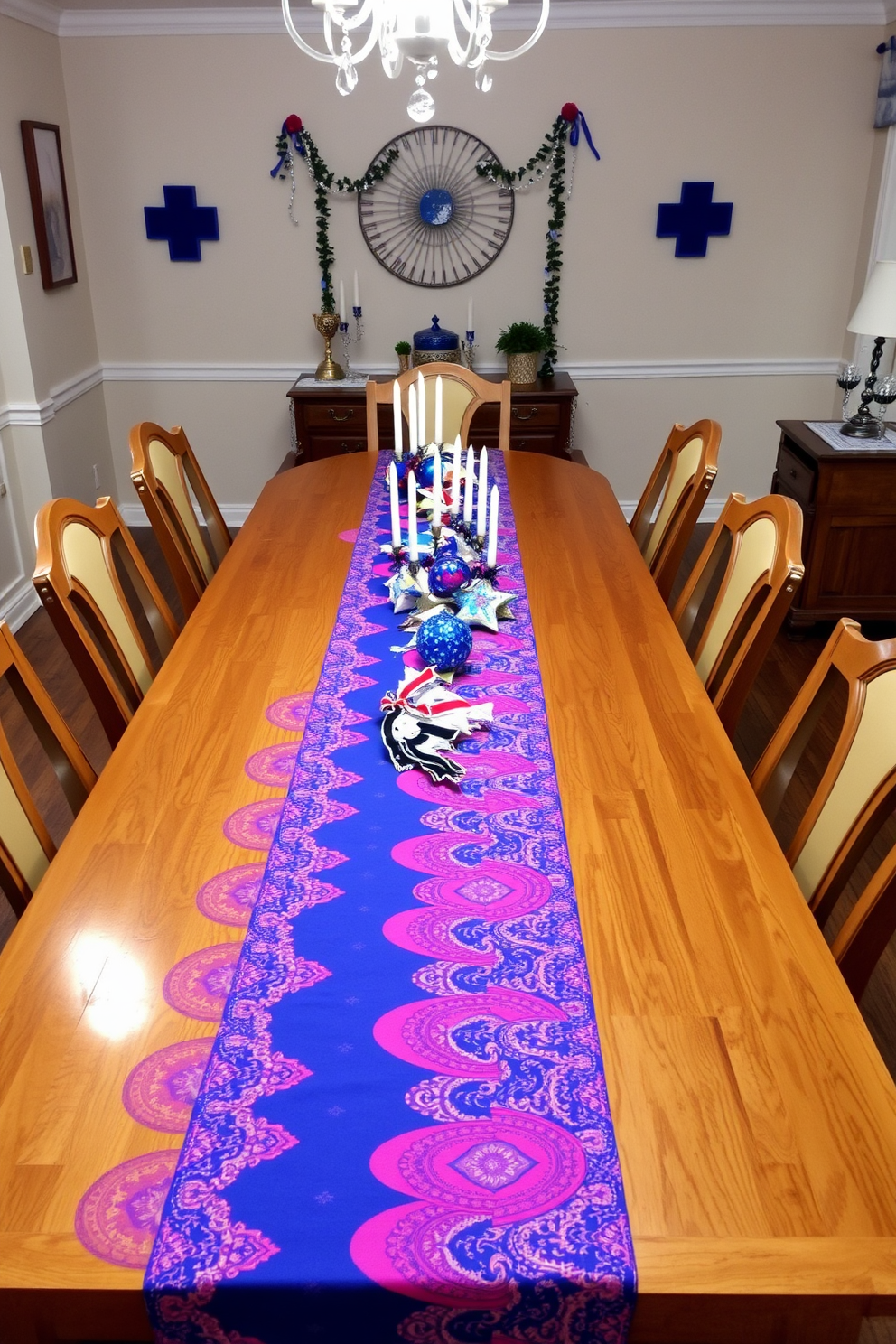 A brightly colored table runner stretches across a long wooden dining table, adorned with festive decorations for Hanukkah. Surrounding the table are elegant chairs, and the walls are decorated with blue and white accents, creating a cheerful and inviting atmosphere.