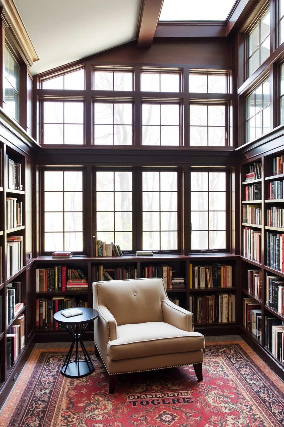 A cozy basement home library featuring floor-to-ceiling windows that flood the space with natural light. The room is adorned with dark wooden bookshelves filled with an array of books, and a plush reading nook with a comfortable armchair and a small side table.