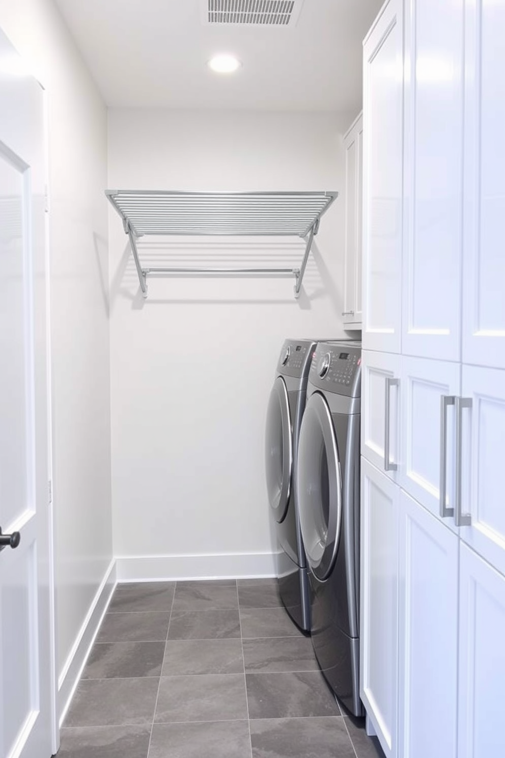 A stylish basement laundry room featuring a wall-mounted drying rack for efficiency. The room includes a sleek washer and dryer set with a countertop above for folding clothes, and the walls are painted in a soft gray tone. Storage cabinets line one wall, providing ample space for laundry supplies, while a small utility sink is conveniently placed nearby. The floor is covered in durable vinyl tiles that mimic the look of wood, adding warmth to the space.