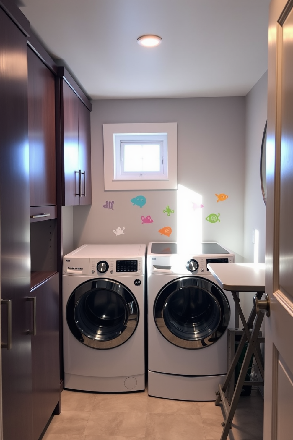 A cozy basement laundry room featuring wall decals that add a personal touch to the space. The room includes a modern washer and dryer set, surrounded by sleek cabinetry for storage and organization. Natural light filters in through a small window, illuminating the cheerful colors of the wall decals. A folding table is positioned beside the appliances, making laundry tasks more convenient and enjoyable.