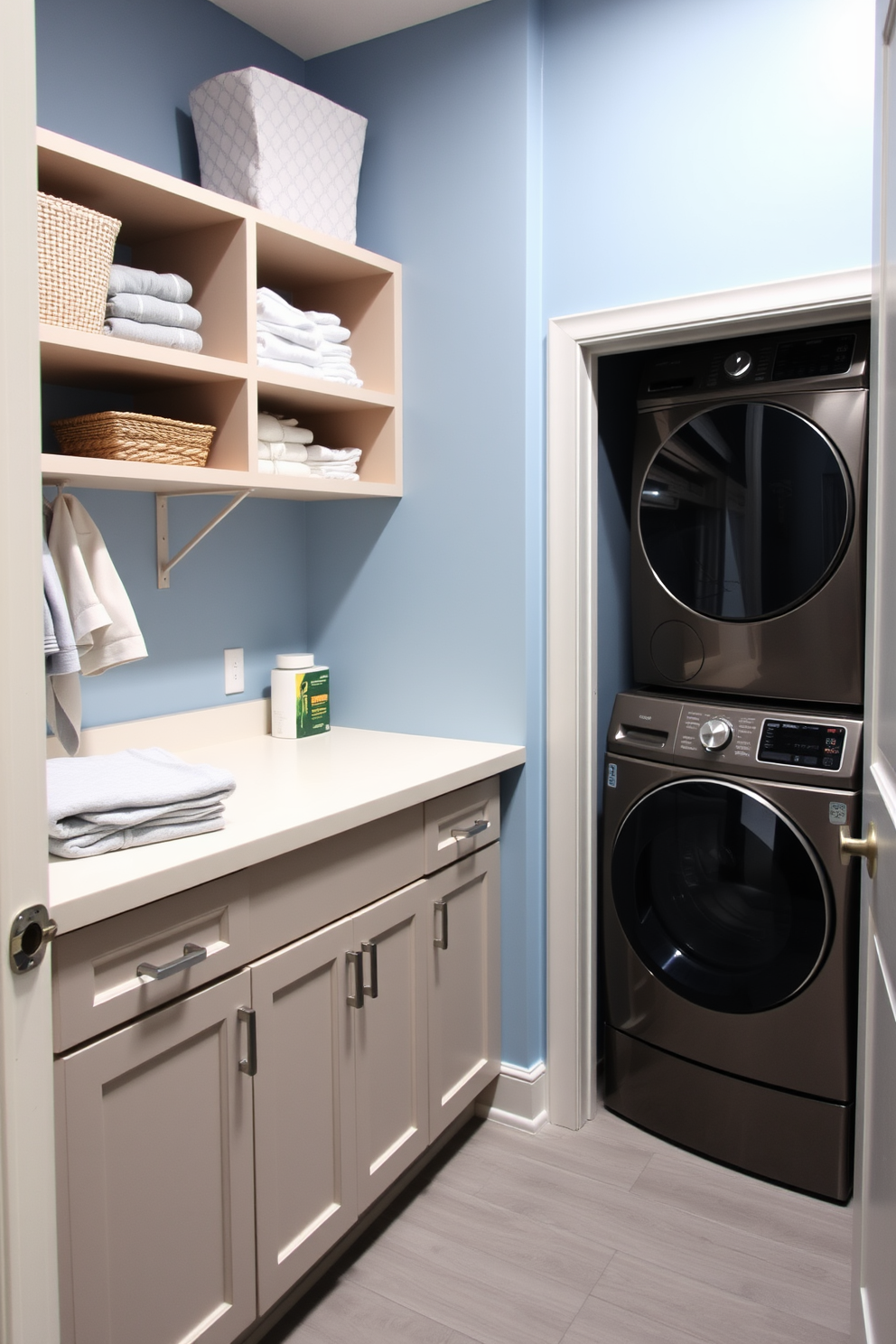 A multi-functional laundry space designed for efficiency and style. The room features a spacious countertop for folding clothes, with open shelving above for easy access to laundry supplies. On one side, a stackable washer and dryer save space while providing convenience. The walls are painted in a soft blue hue, and a durable, water-resistant floor complements the overall aesthetic.