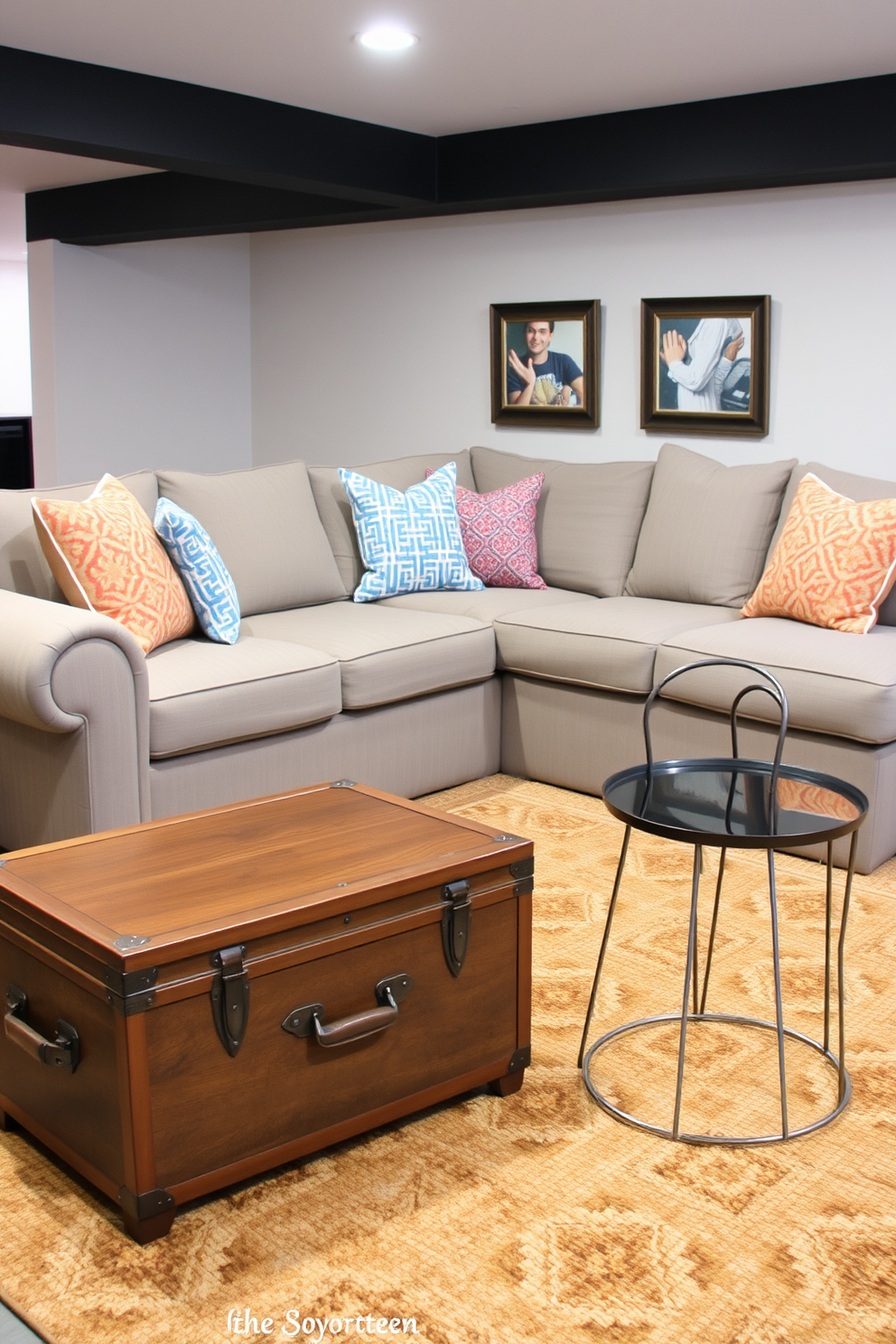 A cozy basement living room features unique side tables that add an eclectic touch to the space. One side table is a vintage trunk repurposed as a coffee table, while another is a modern sculptural piece made of metal. The seating area includes a plush sectional sofa adorned with colorful throw pillows. A warm area rug anchors the space, complementing the diverse styles of the side tables.