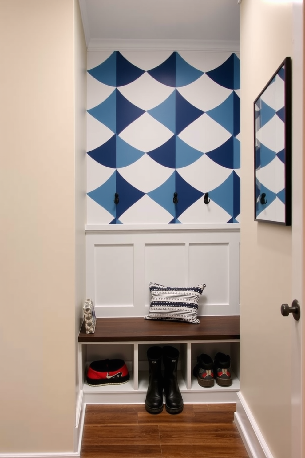 Accent wall with wallpaper or paint. The wall features a bold geometric pattern that adds visual interest to the room while the surrounding walls are painted in a soft neutral tone. Basement Mudroom Design Ideas. The space includes built-in benches with storage underneath and hooks for coats, while the flooring is durable and easy to clean, perfect for muddy shoes.