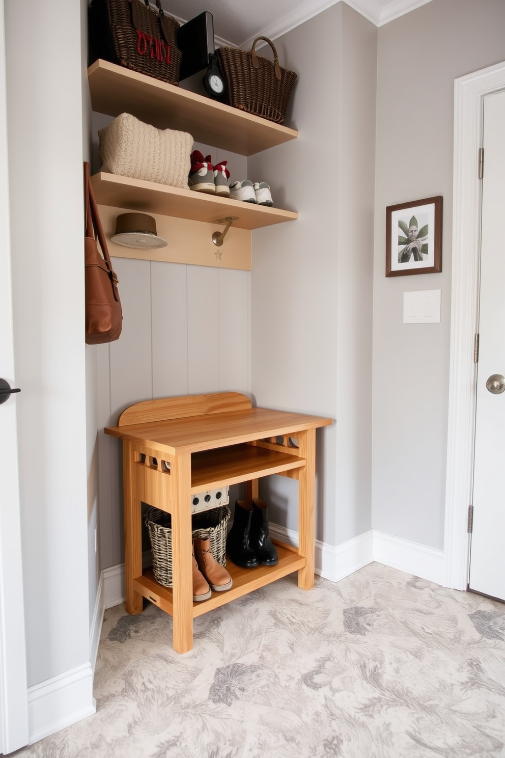 A cozy mudroom design featuring a small wooden desk for organization. The desk is positioned against a wall with shelves above it, neatly storing shoes and bags. The walls are painted in a soft gray tone, creating a calm atmosphere. A durable tile floor with a subtle pattern adds functionality and style to the space.