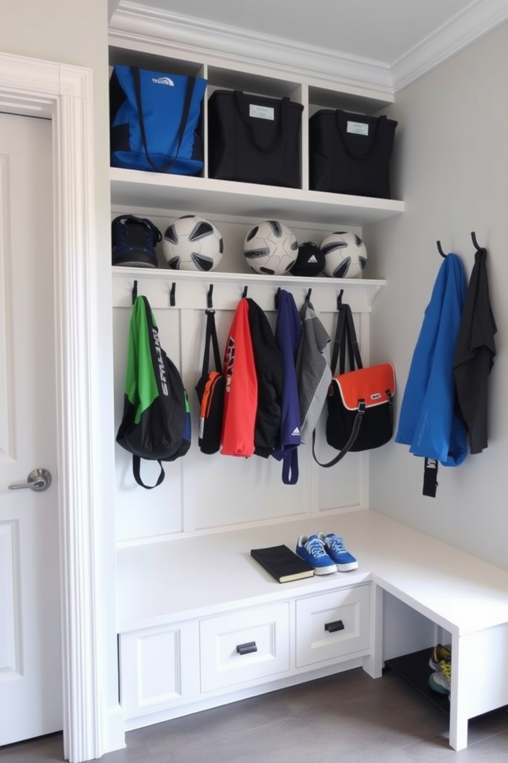 A functional mudroom with designated storage for sports equipment. The space features built-in cubbies with hooks for hanging gear and a bench for easy access to shoes and bags. The walls are painted in a light gray color to create an airy feel. Durable flooring made of waterproof materials ensures easy cleanup after outdoor activities.