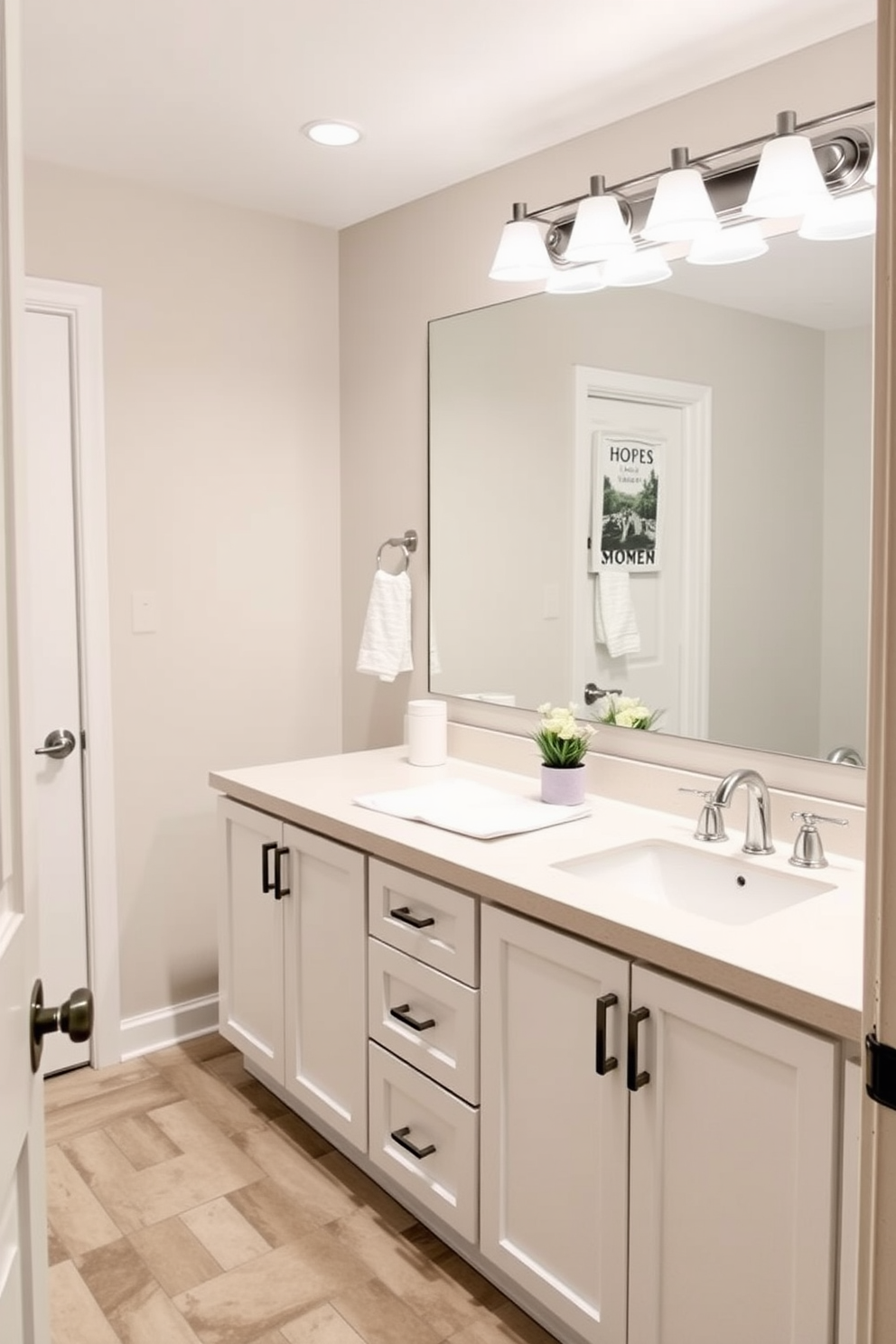 A spacious basement washroom designed for family functionality features dual sinks to accommodate multiple users. The layout includes a large mirror above the sinks and ample storage space to keep essentials organized.