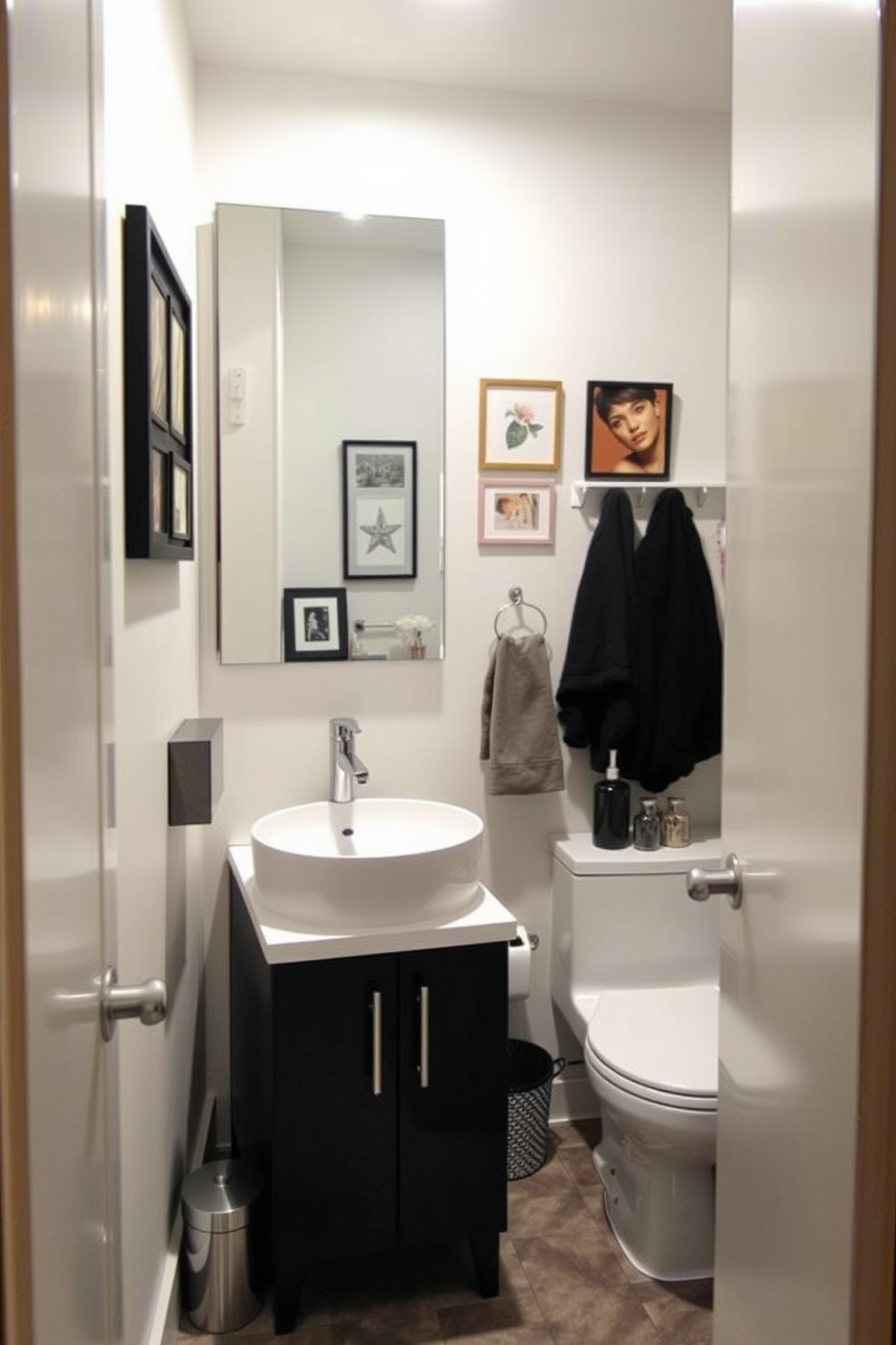 A cozy basement washroom featuring a sleek design with modern fixtures. The walls are adorned with personal artwork that reflects the homeowner's style, adding a unique touch to the space. The washroom includes a compact vanity with a stylish sink and a large mirror that enhances the sense of openness. Soft lighting illuminates the area, creating a warm and inviting atmosphere while maintaining functionality.