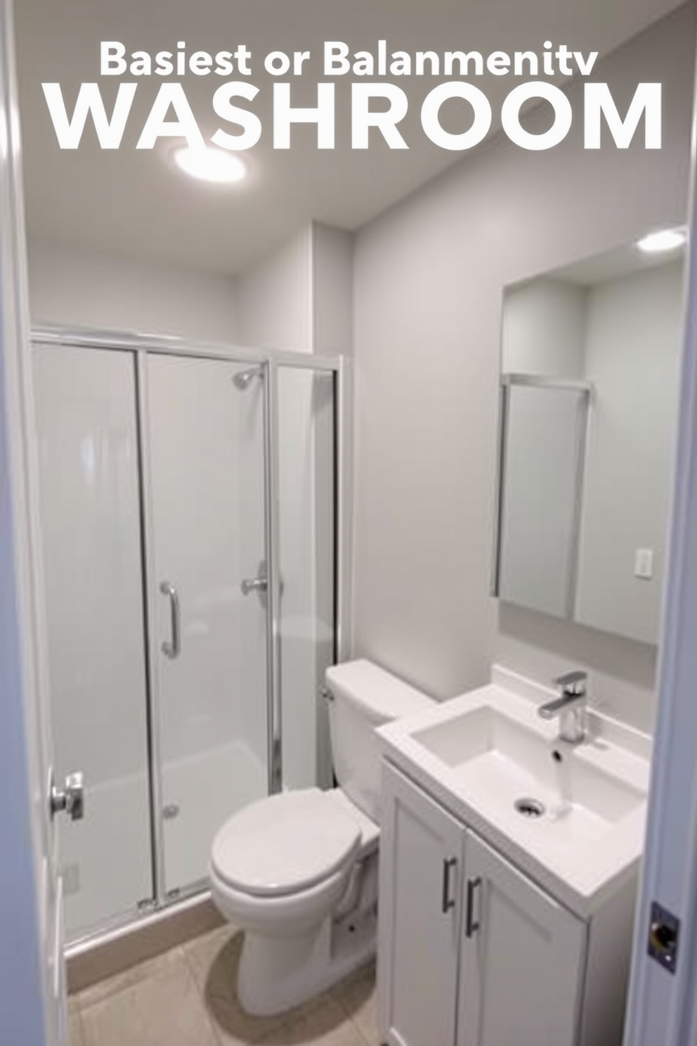 A compact basement washroom design that maximizes space while maintaining functionality. The layout includes a corner shower with glass doors, a wall-mounted toilet, and a small vanity with a sleek sink. The walls are painted in a light gray tone to create an airy feel, complemented by modern fixtures in brushed nickel. A large mirror above the vanity reflects light, enhancing the room's brightness and making it feel more spacious.