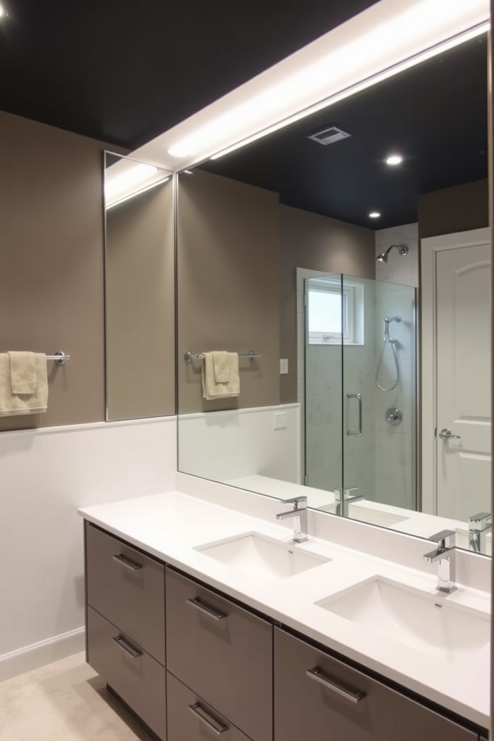 A spacious basement washroom featuring a large mirror that enhances the sense of depth in the room. The design includes sleek cabinetry and modern fixtures, creating a clean and inviting atmosphere.