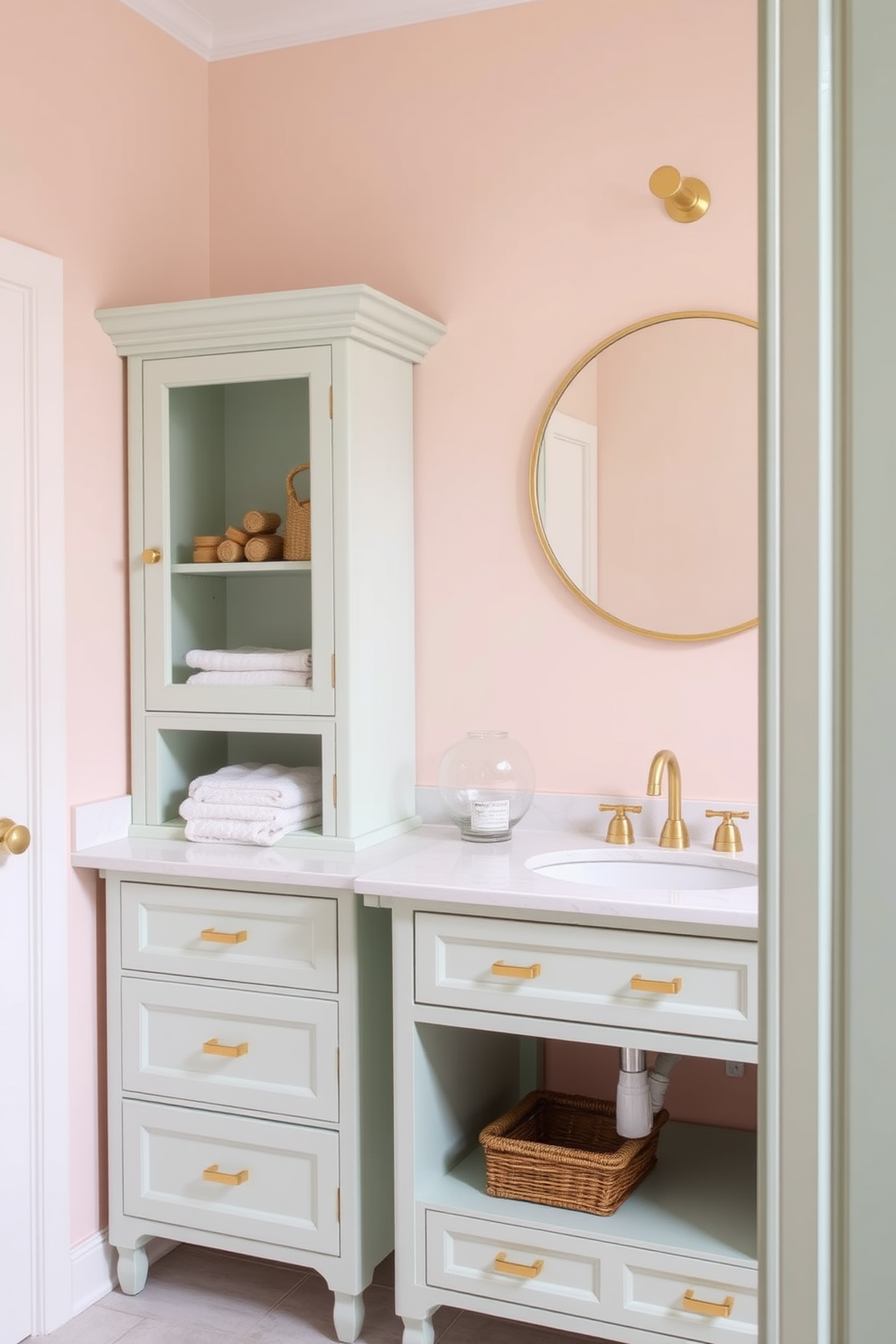 A serene bathroom setting featuring soft pastel colors that create a calming atmosphere. The walls are painted in a light blush pink, complemented by a soft mint green cabinet with elegant gold hardware. The cabinet design includes multiple drawers and open shelving for storage, topped with a white quartz countertop. A round mirror with a thin gold frame hangs above the sink, enhancing the tranquil aesthetic of the space.