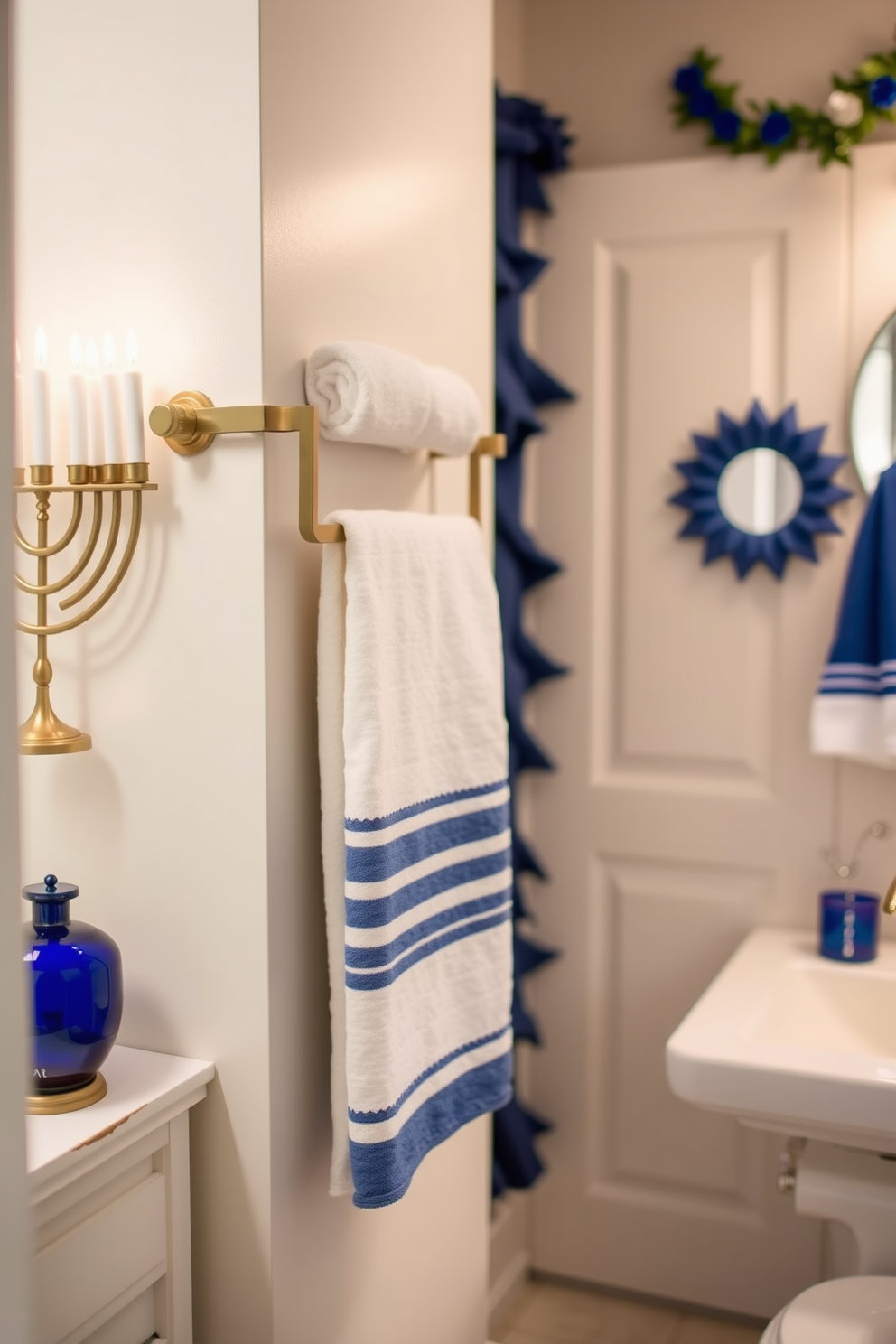 A festive menorah display is beautifully arranged on the countertop, featuring a mix of traditional and modern elements. The menorah is adorned with colorful candles, and surrounding it are decorative ornaments that reflect the spirit of Hanukkah. The bathroom is tastefully decorated for the holiday, with subtle touches of blue and silver. A small festive wreath hangs on the door, and festive towels are neatly arranged, adding a cheerful ambiance to the space.