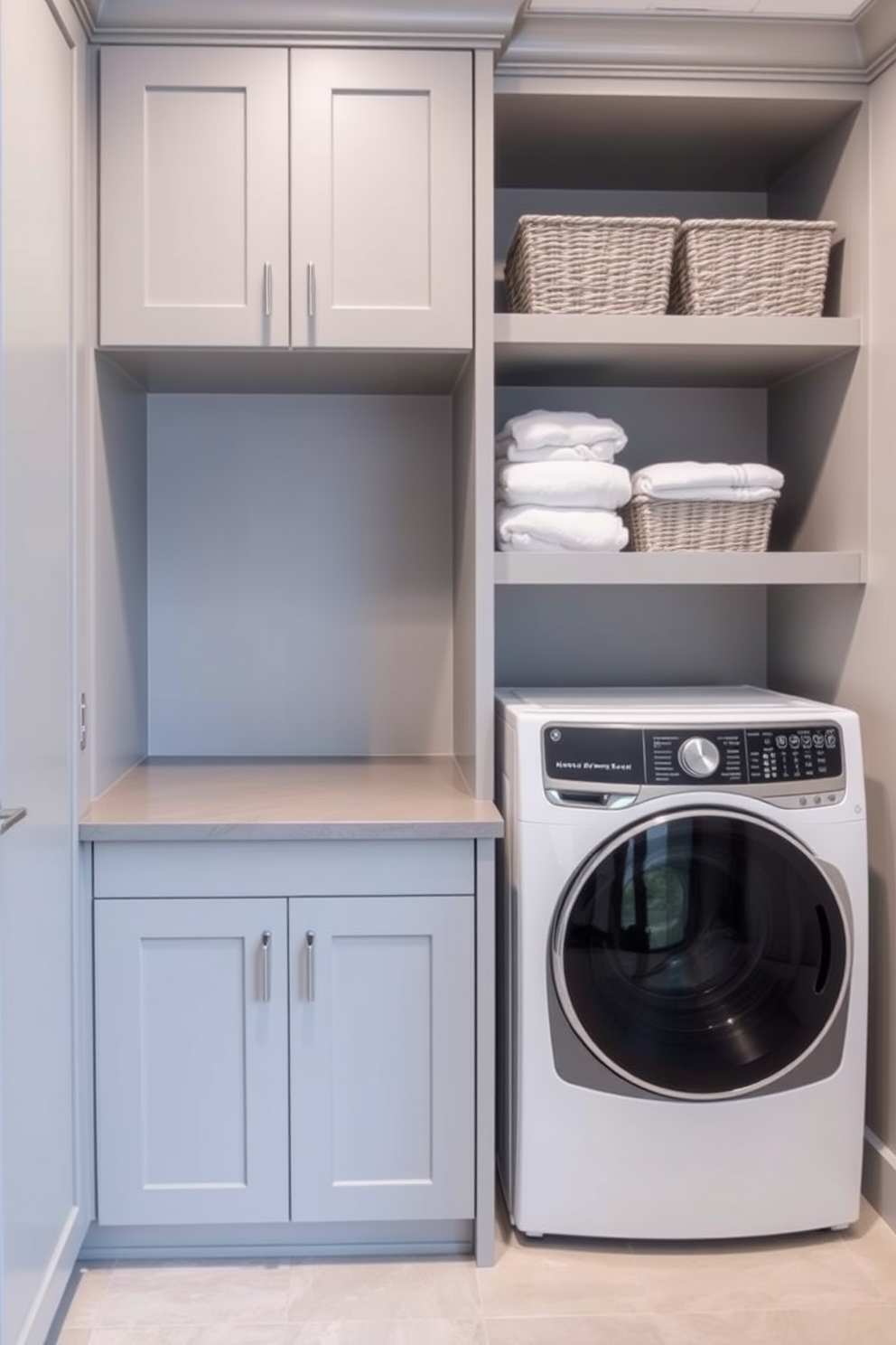 A modern laundry room featuring built-in hampers for organized laundry. The space is designed with sleek cabinetry in a soft gray finish and a countertop that provides ample folding space. To the right, a stylish washer and dryer are seamlessly integrated into the cabinetry. Above the machines, open shelving displays neatly folded towels and decorative storage baskets.