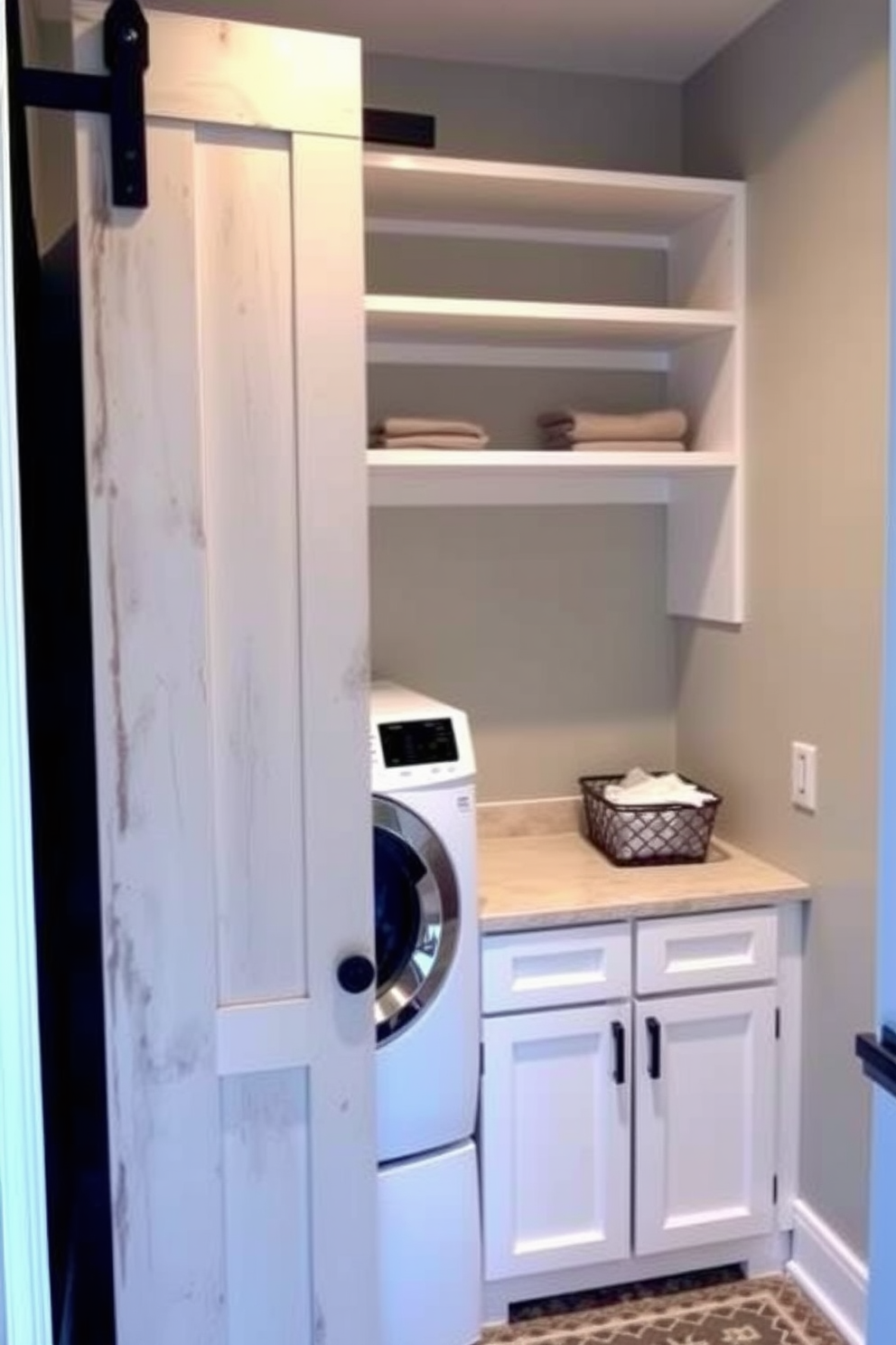 A stylish laundry room featuring a sliding barn door that maximizes space while adding a rustic charm. The room includes a stacked washer and dryer, with open shelving above for storage and organization. The walls are painted in a soft gray tone, complemented by white cabinetry that provides a clean and modern look. A small countertop area is designated for folding laundry, with a decorative basket for added functionality.