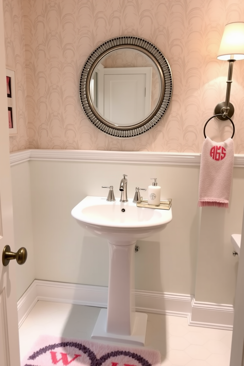 A stylish powder room featuring subtle textures that create a layered effect. The walls are adorned with a soft linen wallpaper in a light beige tone, complemented by a sleek floating vanity with a textured wood finish. A round mirror with a thin black frame hangs above the vanity, reflecting the warm glow of a modern pendant light. The floor is laid with small mosaic tiles in varying shades of gray, adding depth to the overall design.