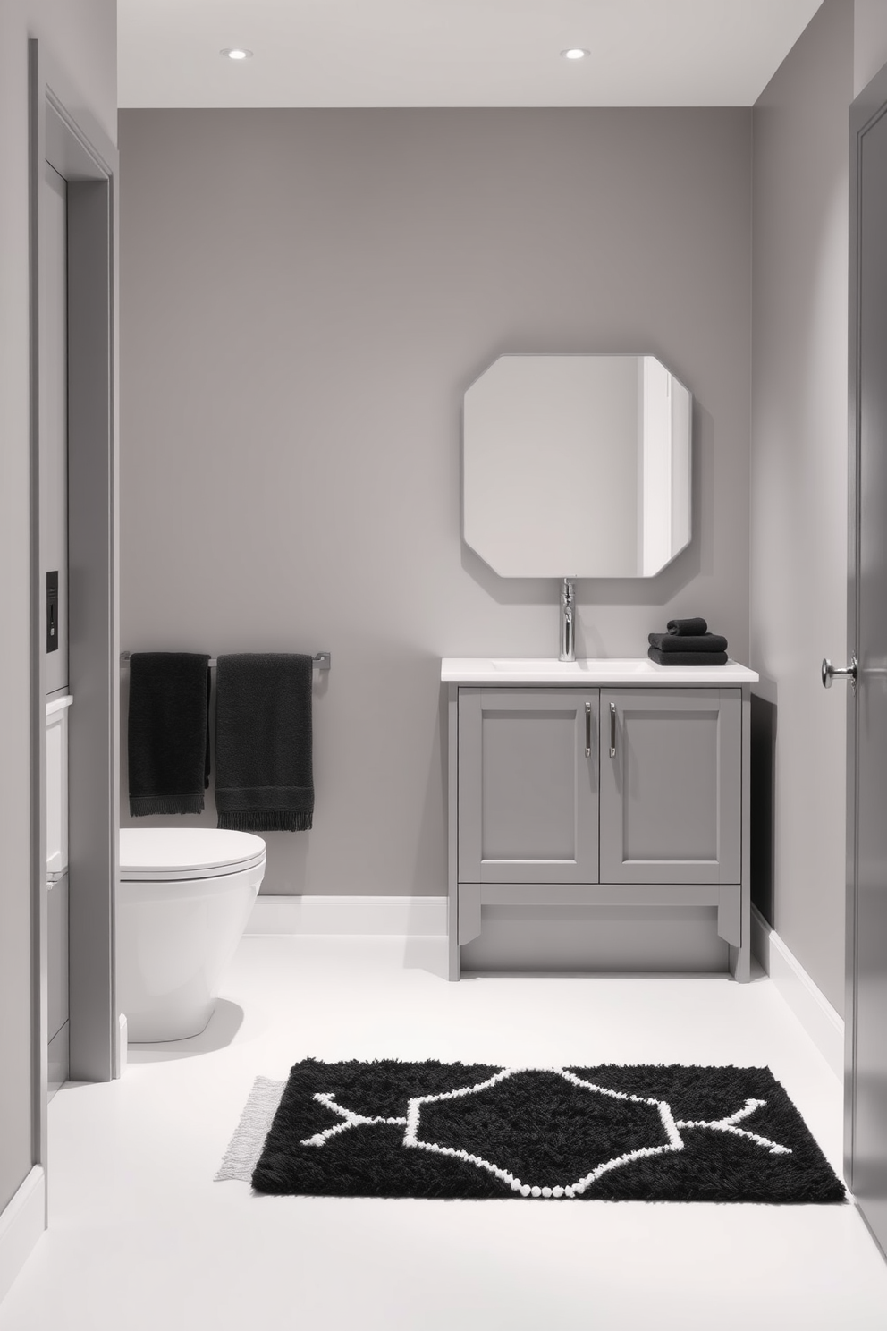 A monochrome bathroom exudes sleek simplicity with its clean lines and cohesive color palette. The walls are painted in a soft gray, complemented by a matching gray vanity featuring a minimalist sink. For the bathroom rug design, consider a plush black rug that contrasts beautifully against the light-colored floor. The rug's geometric pattern adds a modern touch while maintaining the overall monochromatic theme.