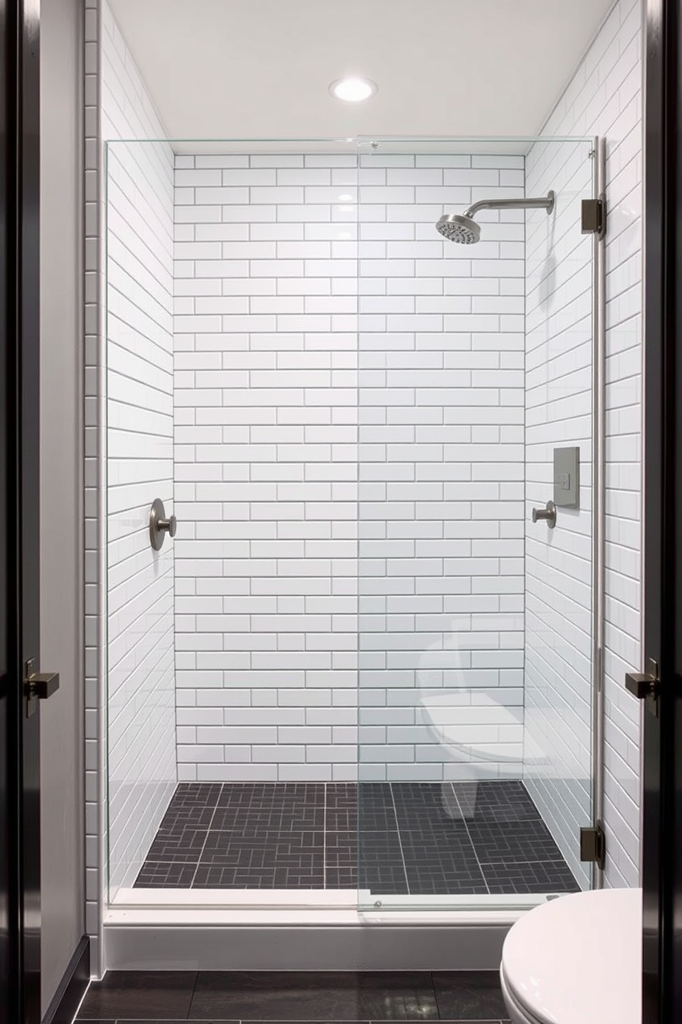 A classic bathroom shower design featuring subway tiles in a crisp white finish. The walls are adorned with sleek subway tiles, creating a timeless backdrop for the modern fixtures. A frameless glass shower enclosure showcases the elegant tile work, while a rainfall showerhead adds a touch of luxury. The floor is complemented with a contrasting dark tile, enhancing the overall sophistication of the space.