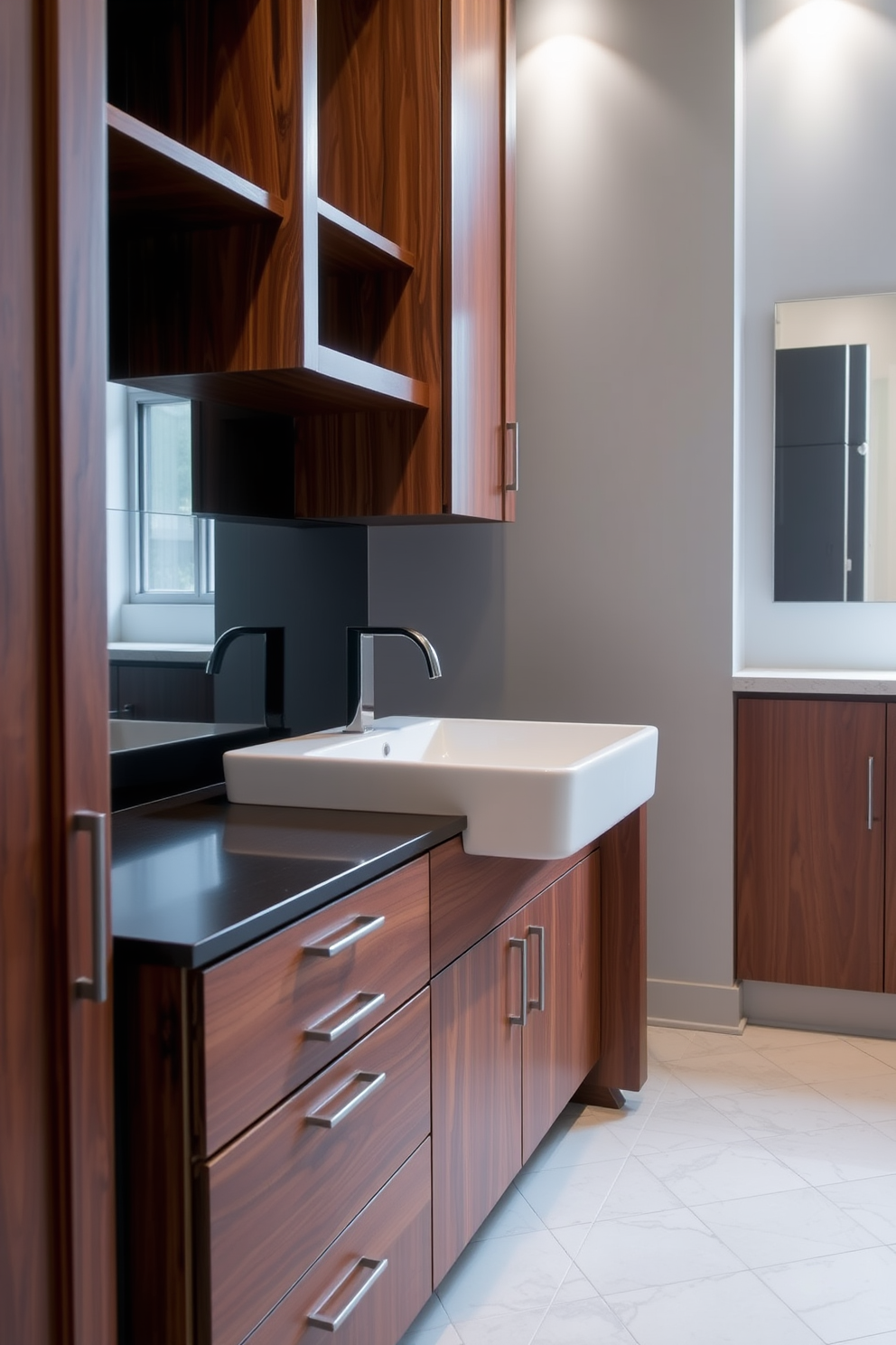 A sleek black sink is the centerpiece of a modern bathroom, exuding sophistication and boldness. The sink is paired with a minimalist chrome faucet and surrounded by a pristine white countertop that enhances its striking appearance. The walls are adorned with large-format tiles in a soft gray hue, creating a calming backdrop. A floating wooden vanity complements the sink, providing ample storage while maintaining an airy feel in the space.