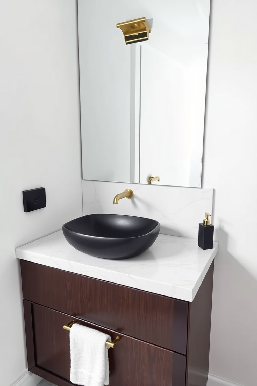 A sleek black sink is the centerpiece of the bathroom, creating a striking contrast against the light-colored walls. The surrounding countertop is made of white marble, enhancing the modern aesthetic with clean lines and elegance. The sink is paired with minimalist fixtures in brushed gold, adding a touch of luxury to the design. Underneath, a dark wood cabinet provides both storage and visual balance to the overall look.