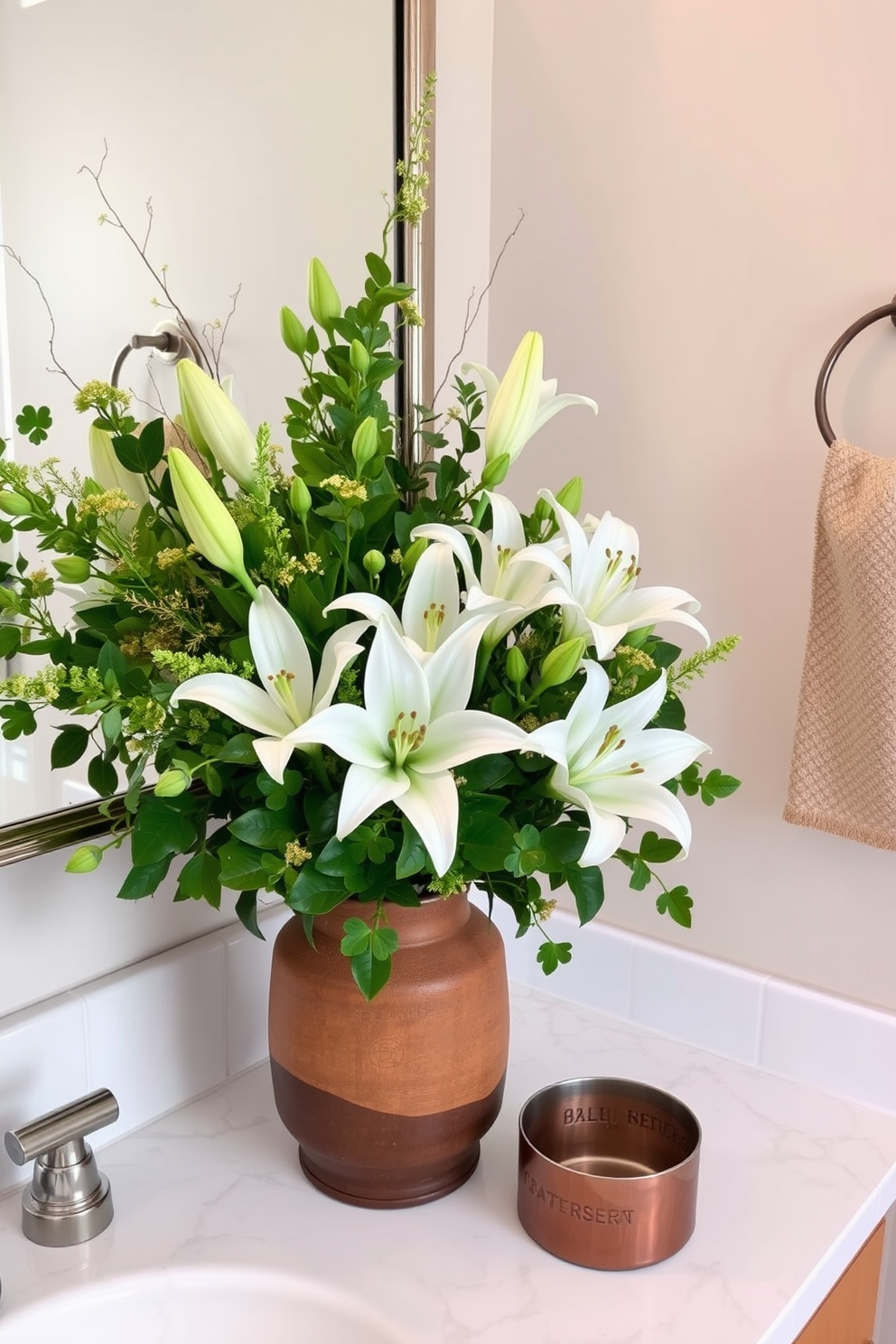 A vibrant seasonal floral arrangement featuring an assortment of green foliage and white lilies sits elegantly in a rustic ceramic vase on the bathroom countertop. To celebrate St. Patrick's Day, delicate shamrock accents are woven throughout the arrangement, enhancing the festive atmosphere with touches of gold and green decor.