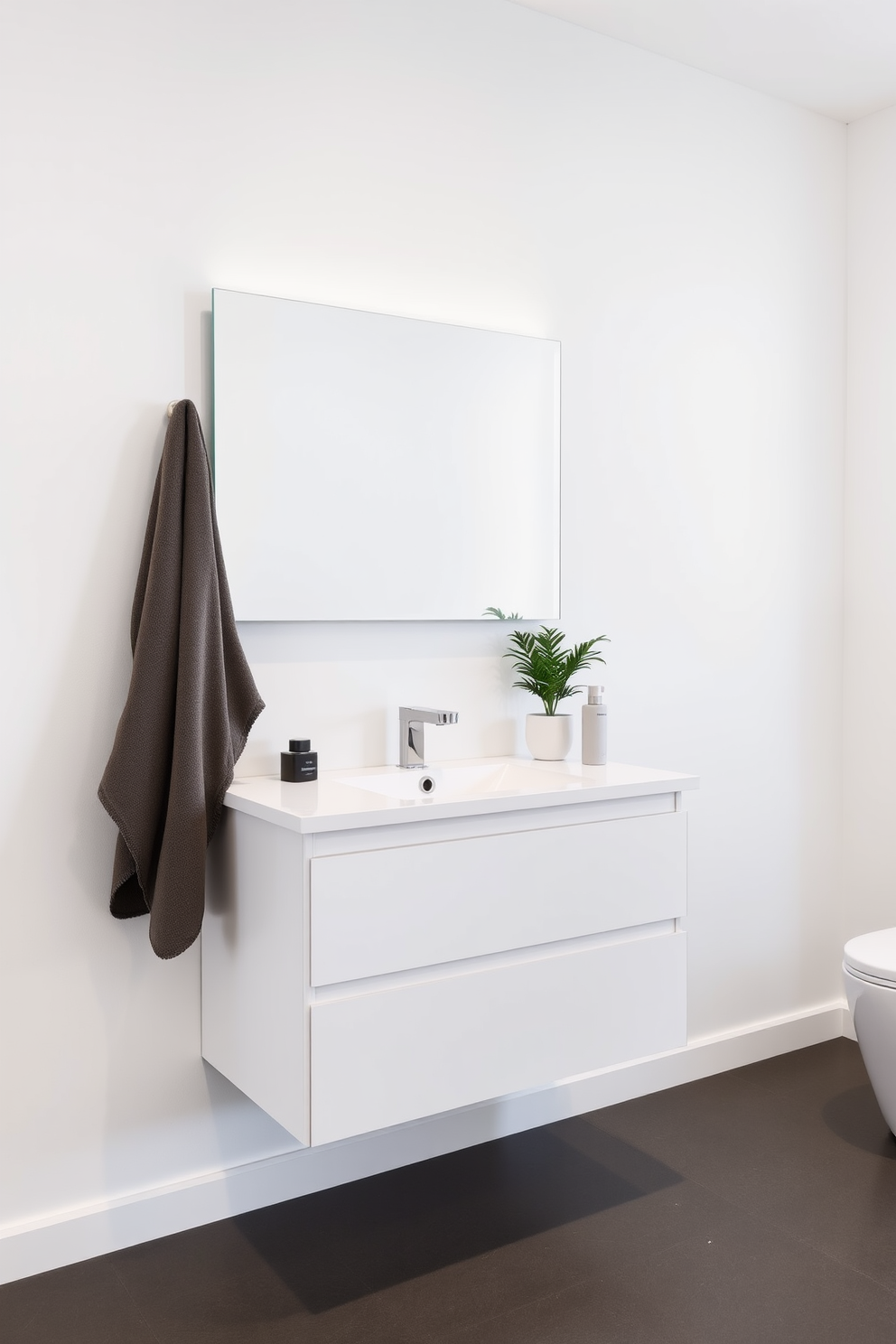 A minimalist wall-mounted vanity showcases clean lines and a sleek design. The vanity features a single, integrated sink with a smooth countertop and ample storage below for a clutter-free look. The walls are painted in a soft white hue, enhancing the sense of space and light. A large, frameless mirror reflects the simplicity of the design, while a small potted plant adds a touch of greenery.