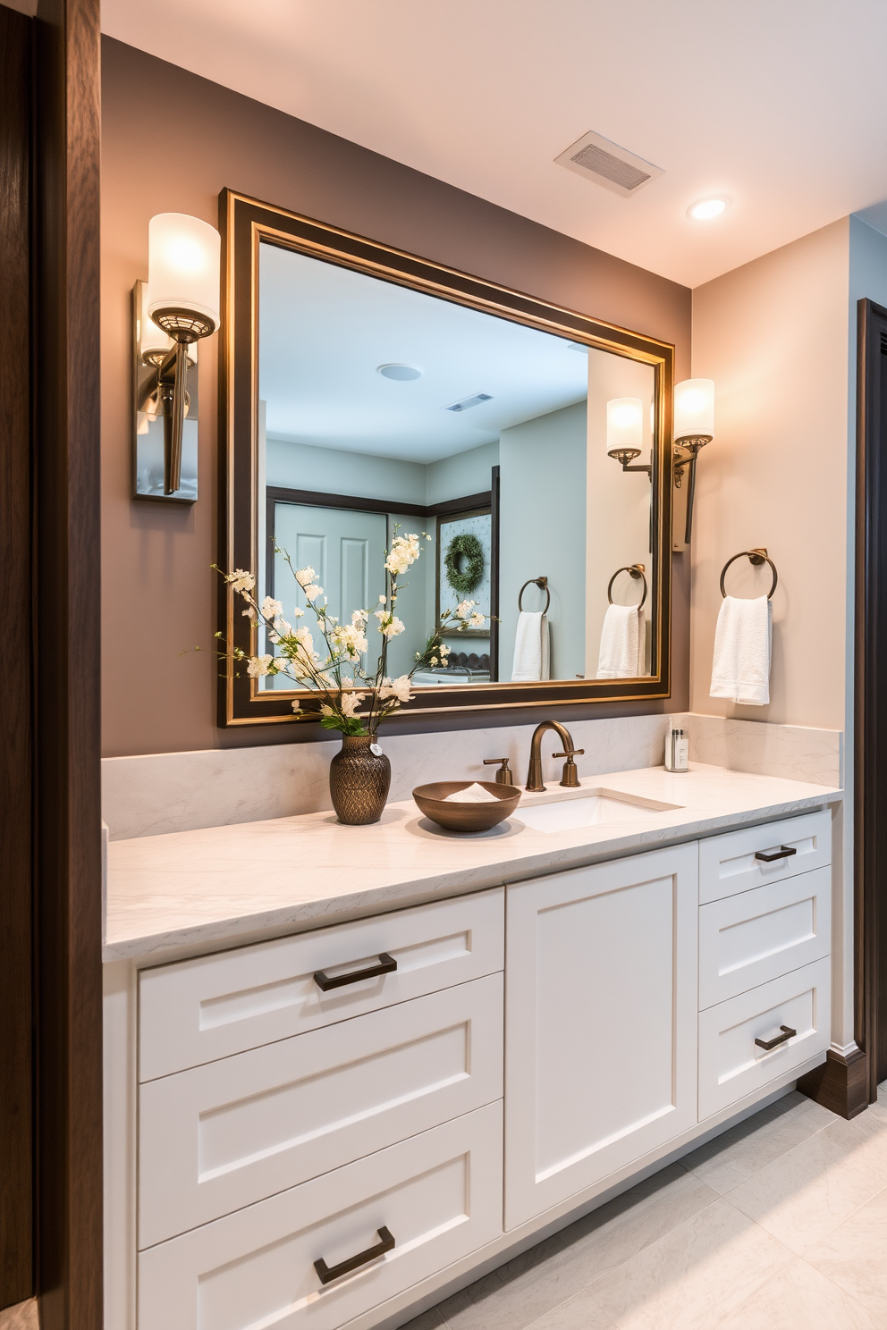 A custom built-in vanity features sleek cabinetry with ample storage space for toiletries and linens. The countertop is adorned with a stunning quartz surface, complemented by a stylish backsplash in a soft neutral tone. Above the vanity, elegant sconces provide warm lighting, enhancing the overall ambiance. A large framed mirror reflects the beauty of the space, creating a sense of openness and sophistication.