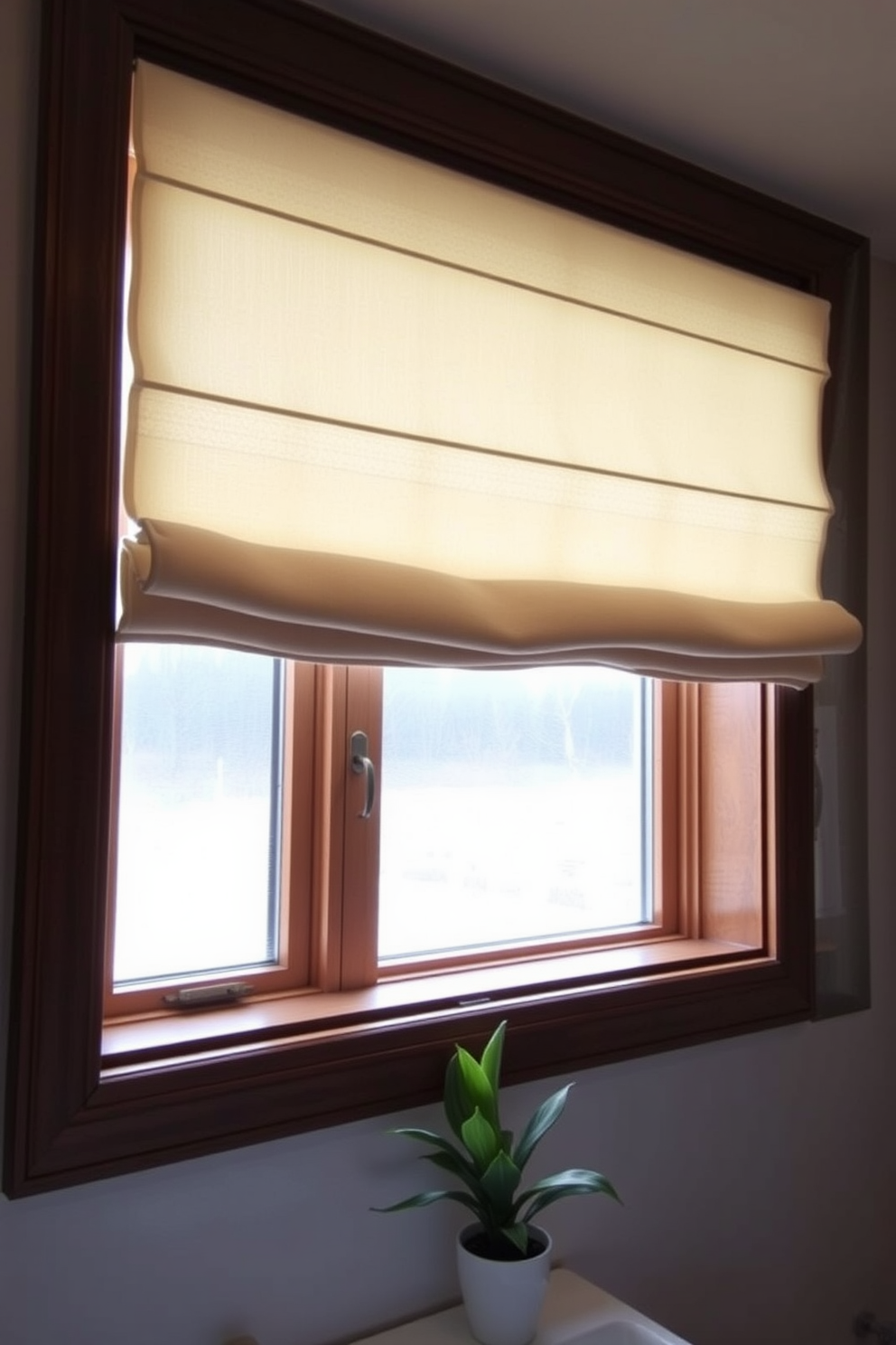 A chic bathroom window adorned with elegant Roman shades offers both style and functionality. The soft fabric in a neutral tone complements the overall decor while providing the perfect amount of light filtration. The window design features a sleek wooden frame that enhances the modern aesthetic of the space. Below the window, a small potted plant adds a touch of greenery and freshness to the room.