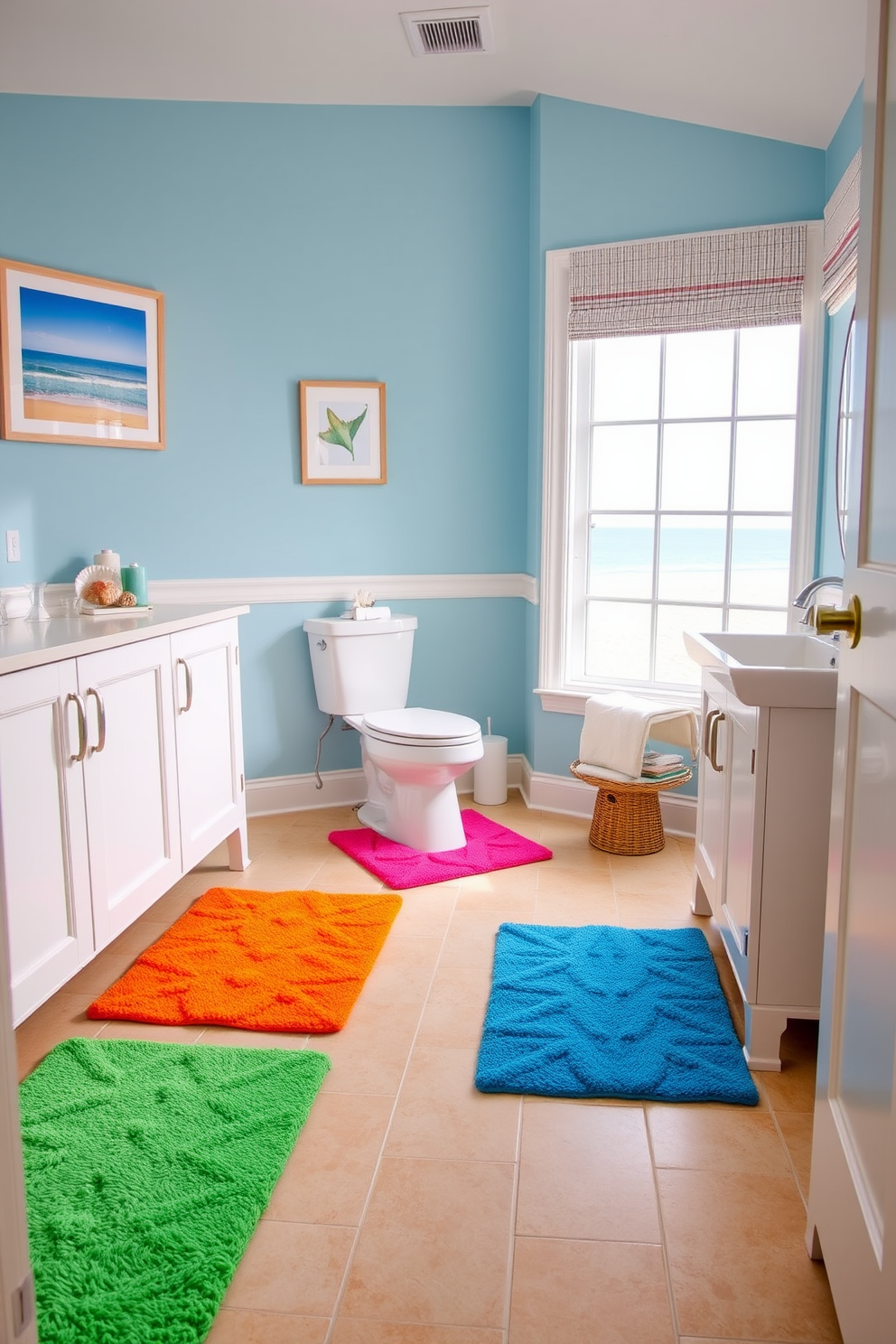 Brightly colored bath mats in vibrant hues create a striking contrast against the sandy beige floor tiles. The bathroom features coastal-themed decor with seashell accents and a large window that lets in natural light, enhancing the cheerful atmosphere. The walls are painted in a soft ocean blue, complemented by white cabinetry and a sleek, modern sink. A framed beach landscape hangs above the toilet, tying the entire beach bathroom design together harmoniously.