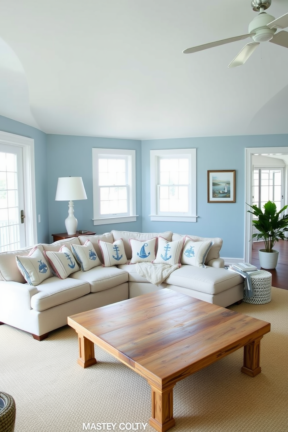 A serene beach living room with light blue walls and crisp white trim. The space features a comfortable sectional sofa adorned with nautical-themed cushions and a large coffee table made of reclaimed wood.