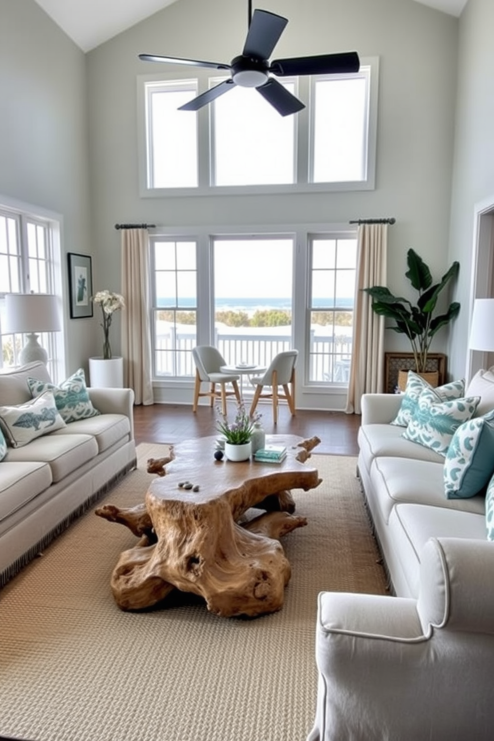 A beach-inspired living room featuring a driftwood coffee table as the centerpiece. Surrounding the table are plush, light-colored sofas adorned with ocean-themed throw pillows, and large windows allow natural light to flood the space.