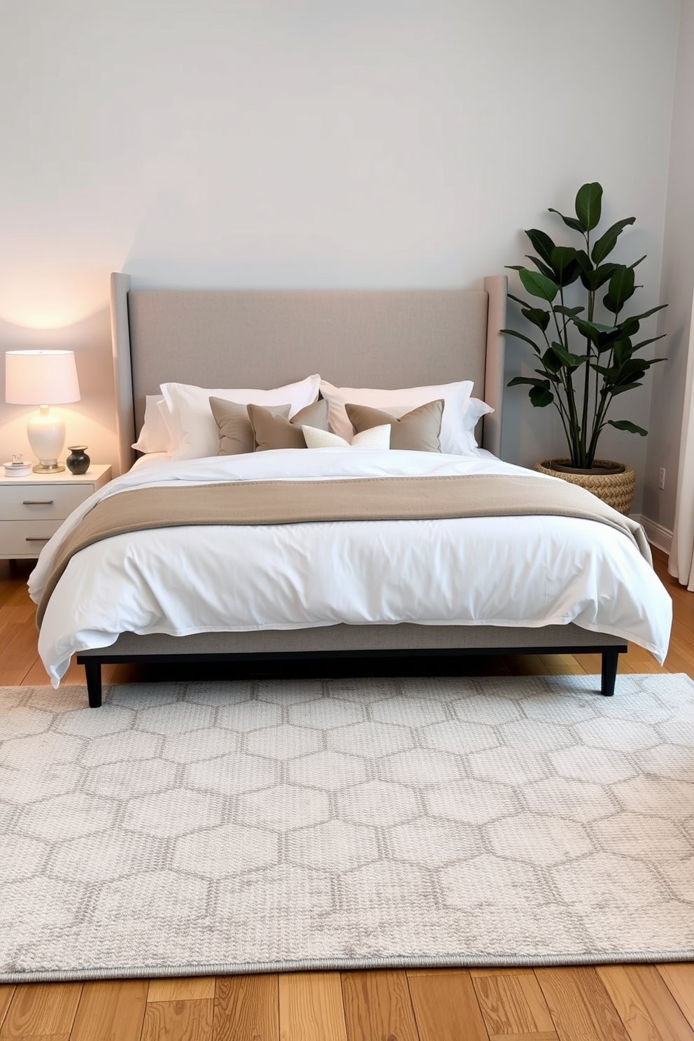 A cozy bedroom featuring a plush area rug that defines the sleeping space. The bed is dressed in soft linens with an oversized headboard, and a bedside table holds a stylish lamp. Incorporate a second area rug under a seating nook with a small coffee table and comfortable chairs. The walls are painted in a calming color, and a large window lets in natural light, enhancing the inviting atmosphere.