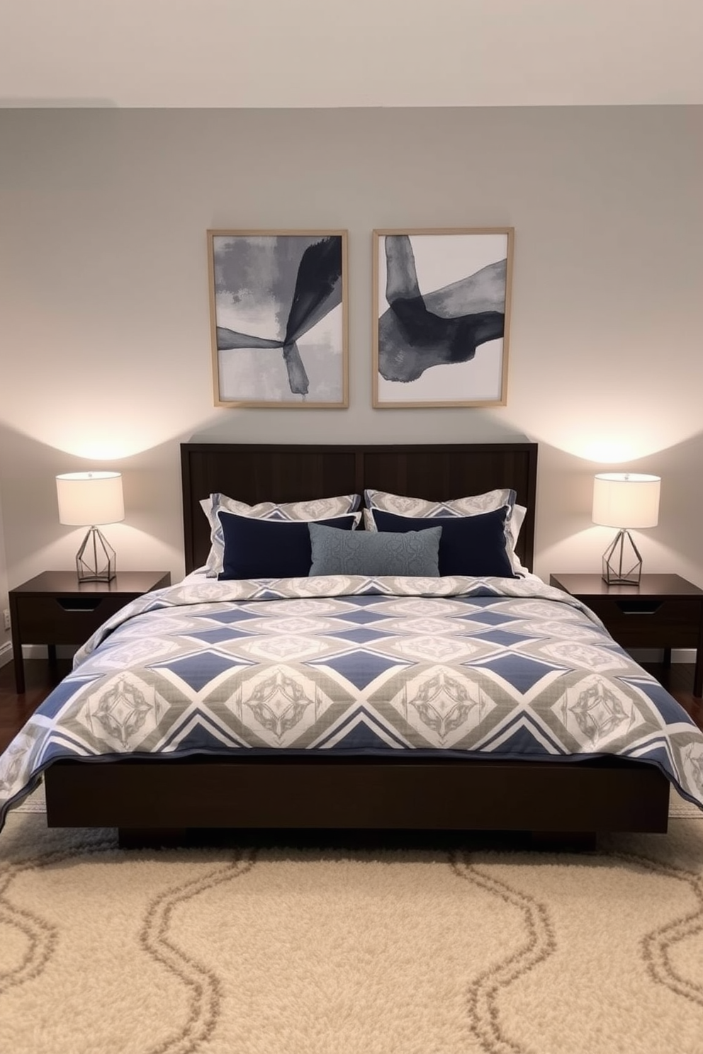 A cozy bedroom for couples featuring a king-sized bed with a geometric patterned duvet cover in shades of navy and white. The walls are painted a soft gray, and a pair of abstract art pieces with geometric designs hang above the bed. On either side of the bed, sleek nightstands in a dark wood finish hold modern lamps with geometric bases. A plush area rug with a subtle geometric pattern lies beneath the bed, adding warmth and texture to the space.