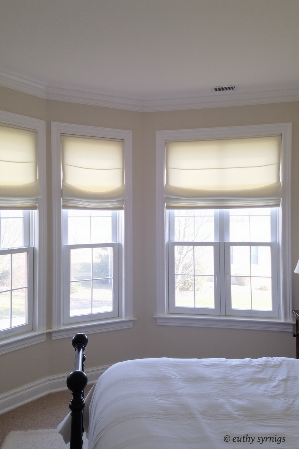 A serene bedroom setting featuring large windows adorned with Roman shades in soft, calming colors. The shades gently filter natural light, creating a tranquil atmosphere that enhances the overall comfort of the space.