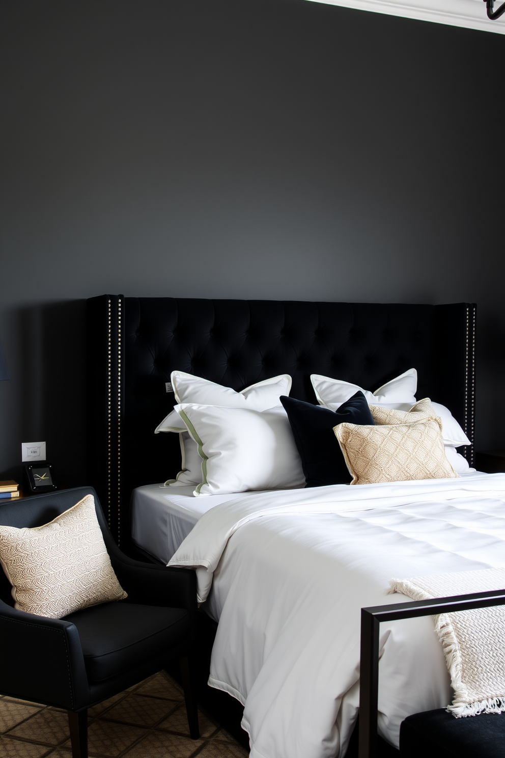 A stylish black accent chair is placed in the corner of the room, adding a touch of elegance to the overall design. The walls are painted in a deep charcoal shade, creating a dramatic backdrop for the luxurious bedding and decor. The bed features a plush black upholstered headboard, complemented by crisp white linens and a mix of textured throw pillows. A sleek nightstand with metallic accents sits on either side of the bed, enhancing the modern aesthetic of the space.