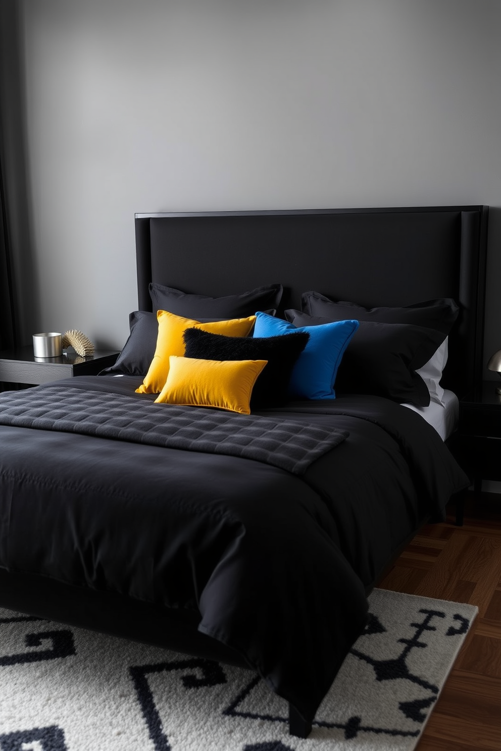 A modern black bedroom featuring a sleek black bed frame adorned with luxurious black bedding. Colorful accent pillows in vibrant hues of blue and yellow are scattered across the bed, adding a pop of color to the monochromatic scheme. The walls are painted in a soft gray to create a warm contrast with the black elements. A stylish area rug with abstract patterns lies beneath the bed, enhancing the overall aesthetic of the space.