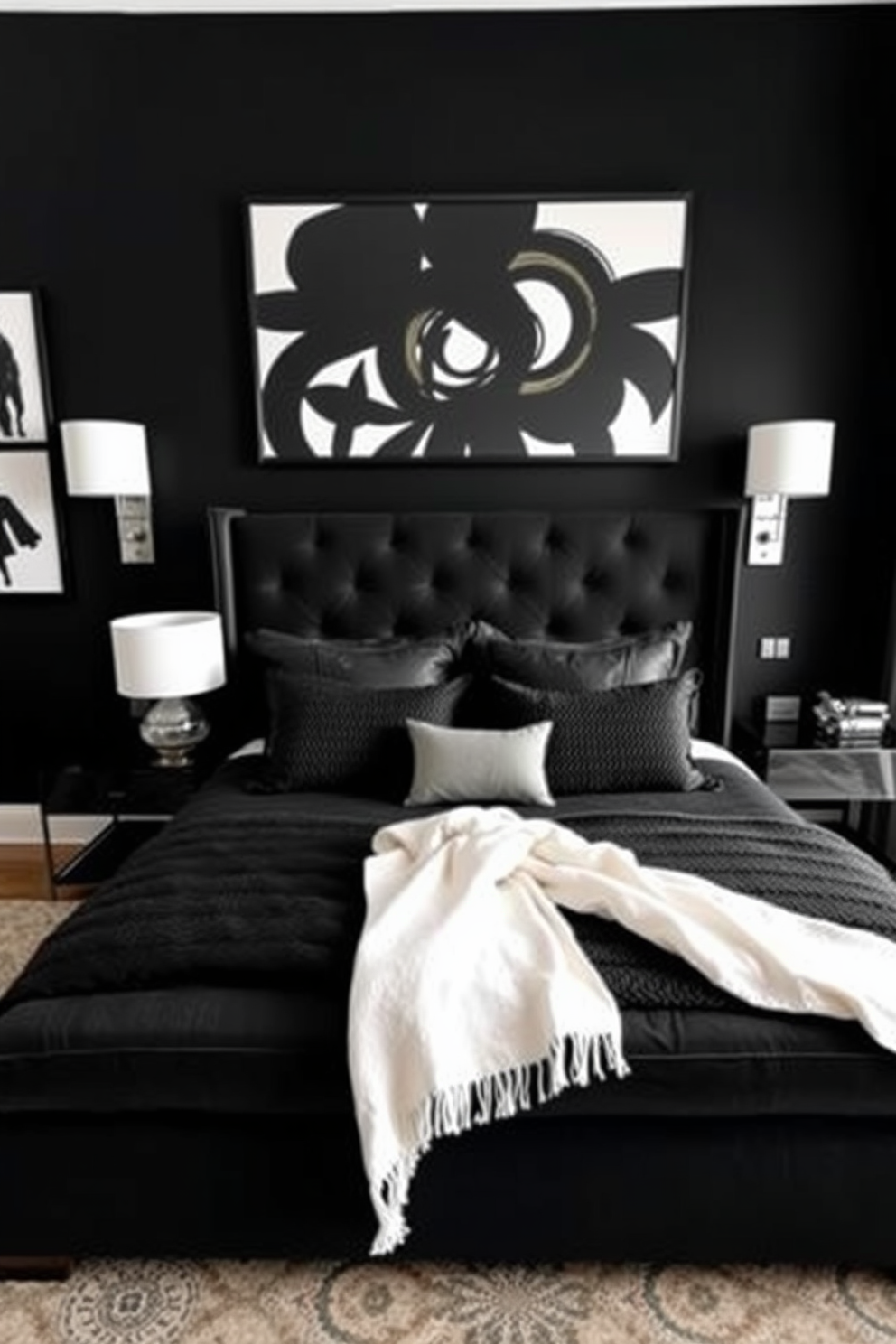 A striking black bedroom featuring a large upholstered bed with a plush black headboard. The walls are adorned with bold black and white artwork, creating a dramatic focal point that enhances the luxurious feel of the space. A sleek bedside table on either side of the bed holds modern table lamps with white shades. The bedding is a mix of textured black fabrics, complemented by a cozy white throw draped across the foot of the bed.