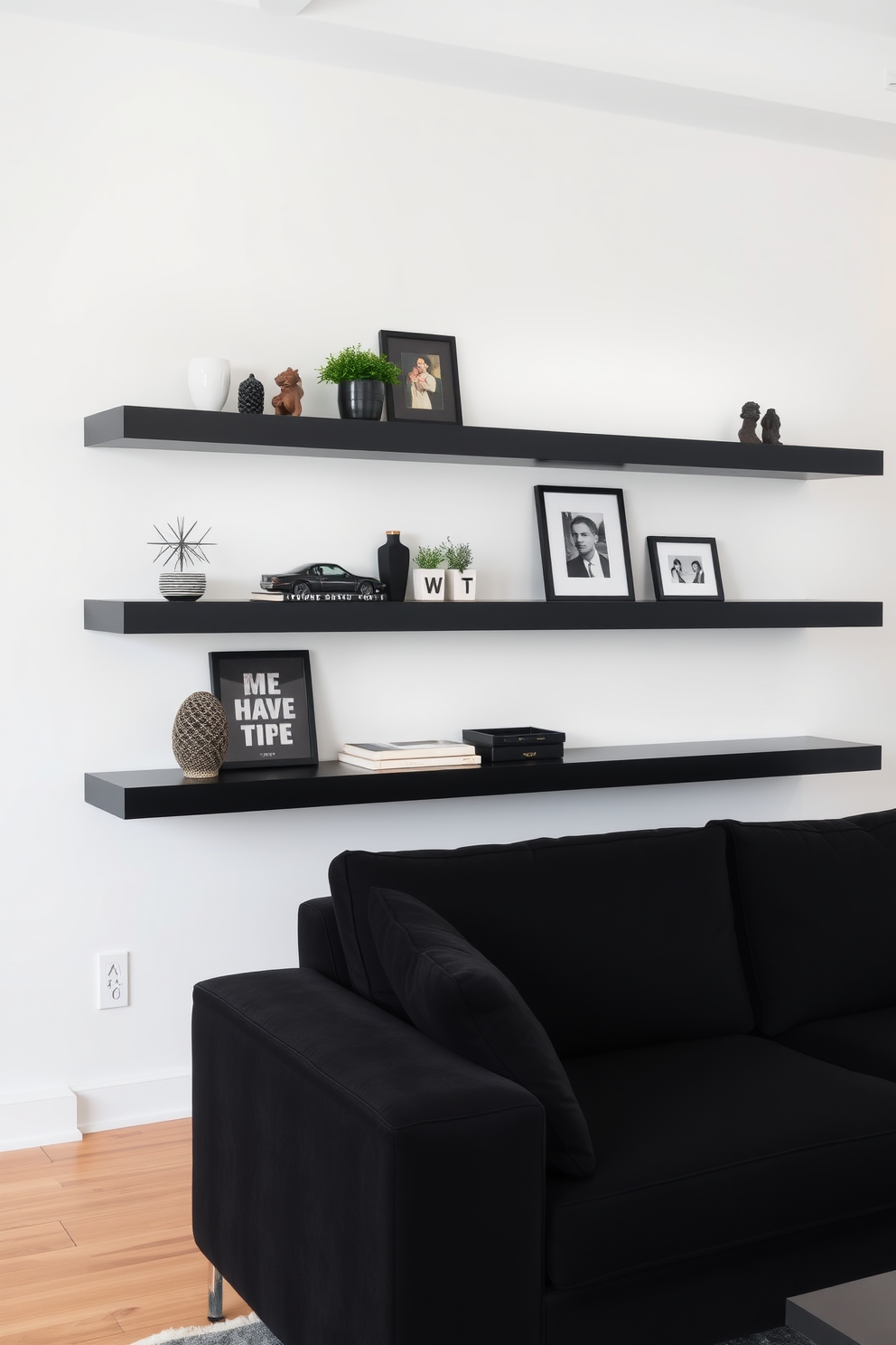 A stylish living room features sleek floating shelves that provide a modern appeal and showcase curated decor items. The focal point of the room is a plush black couch, elegantly positioned to invite relaxation while complementing the overall aesthetic.