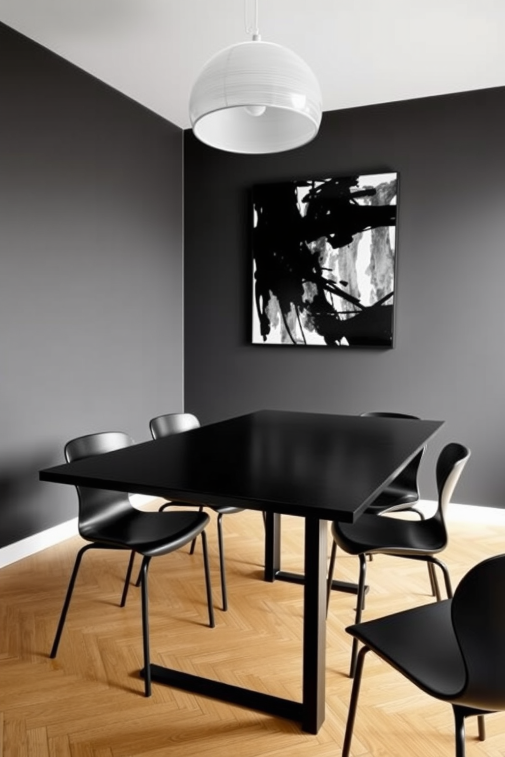 A minimalist black dining room features a sleek rectangular table with a matte black finish surrounded by modern black chairs with clean lines. The walls are painted in a deep charcoal color, and a large abstract artwork in monochrome hangs above the table, adding a touch of sophistication.