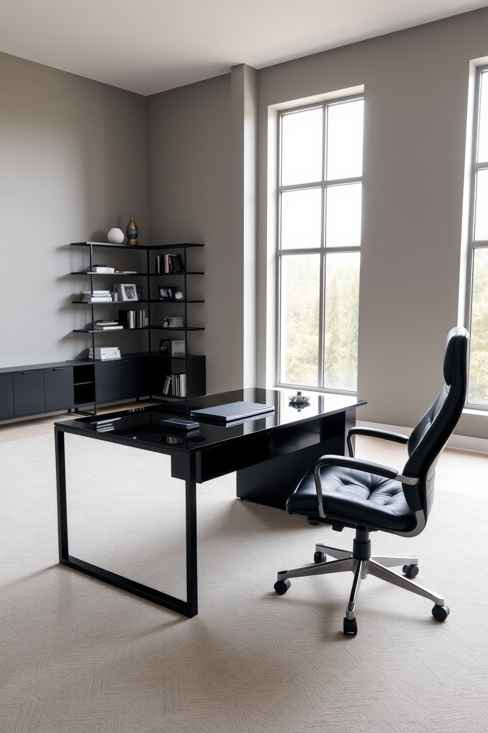 A sleek black desk made of glass and metal sits in the center of a spacious home office. The walls are painted in a soft gray tone, with large windows allowing natural light to flood the room, creating an open and airy atmosphere. Minimalist shelving units in black are mounted on the walls, displaying a curated selection of books and decorative items. A comfortable ergonomic chair in black leather complements the desk, providing a stylish yet functional workspace.